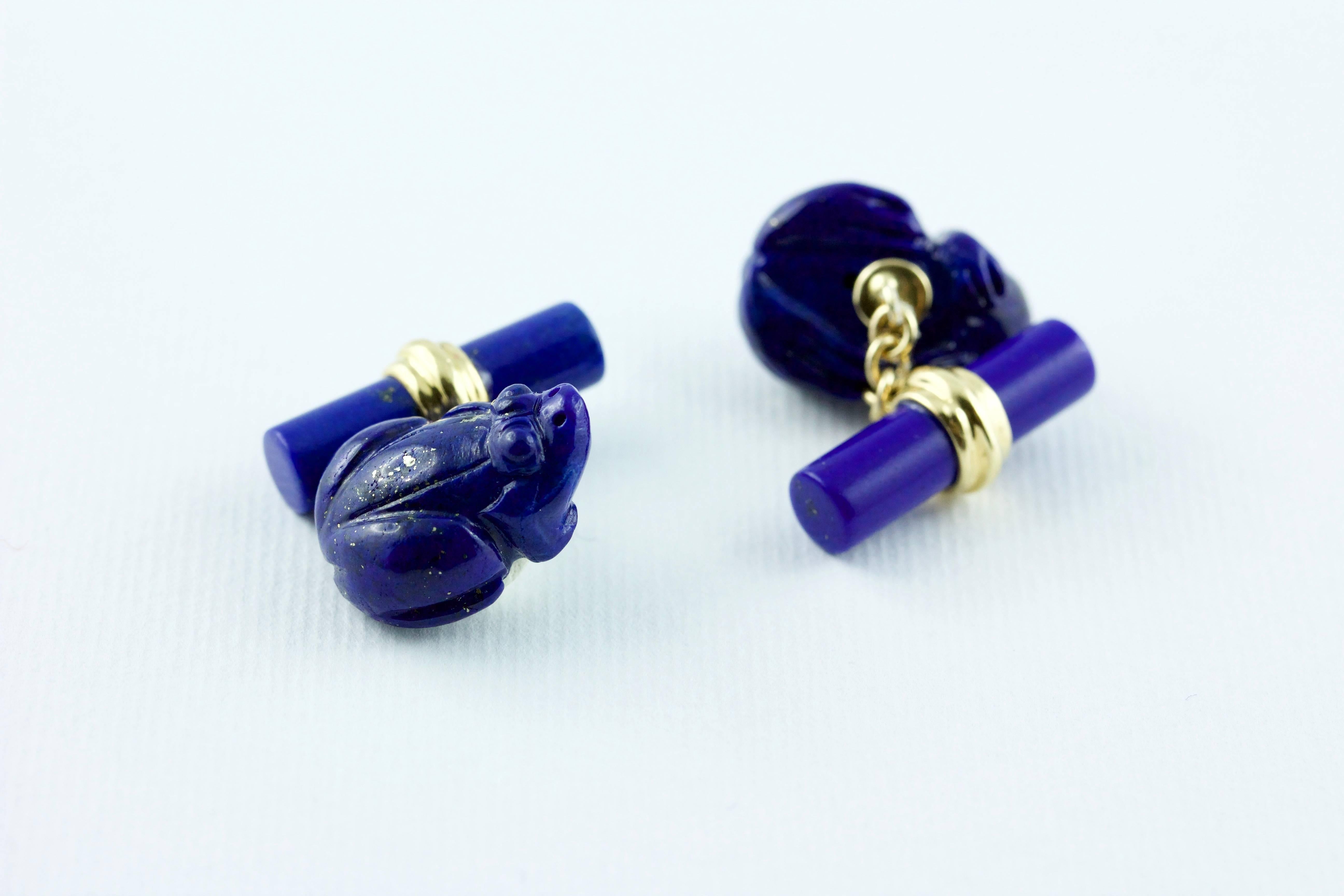 This playful pair of cufflinks is made of Lapis Lazuli and its front face is carved to depict the body a frog made of Lapis Lazuli. The simple back toggle is a piece of cylindrical Lapis Lazuli, while an 18k yellow gold post connects these two