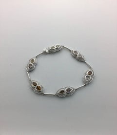 18 Karat Gold Bracelet with Fancy Color Pear Shape Diamonds and Round Diamonds