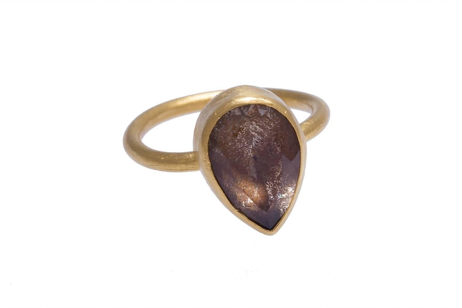 24K Yossi Harari ring containing a bezel set pear shape faceted smoky quartz.


