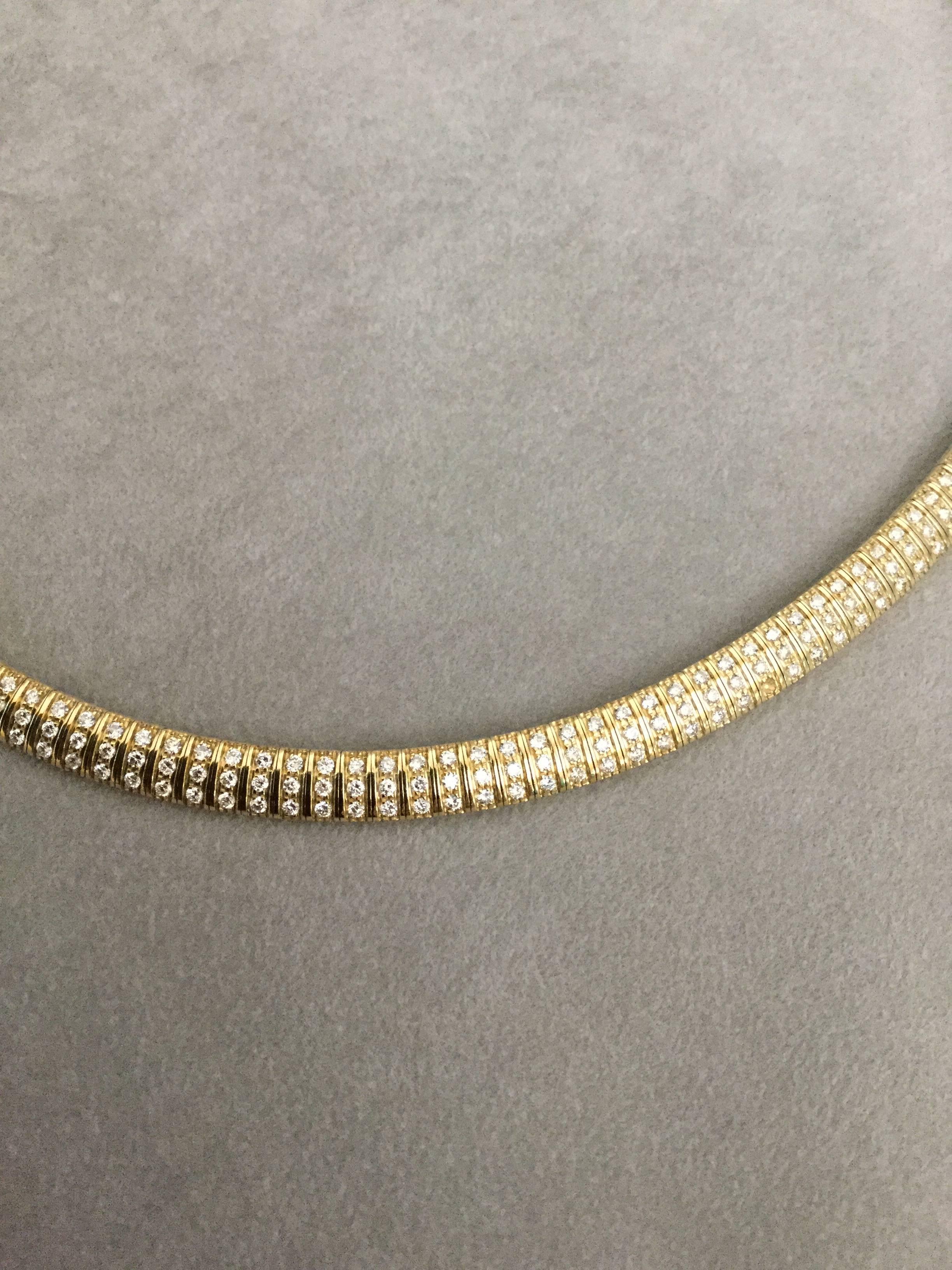 14K yellow gold domed Omega necklace set with 165 diamonds weighing combined 3.95 carats. Statement piece that can be worn casual or dressed up. 
Tip: For formal occasions add an enhancer.

