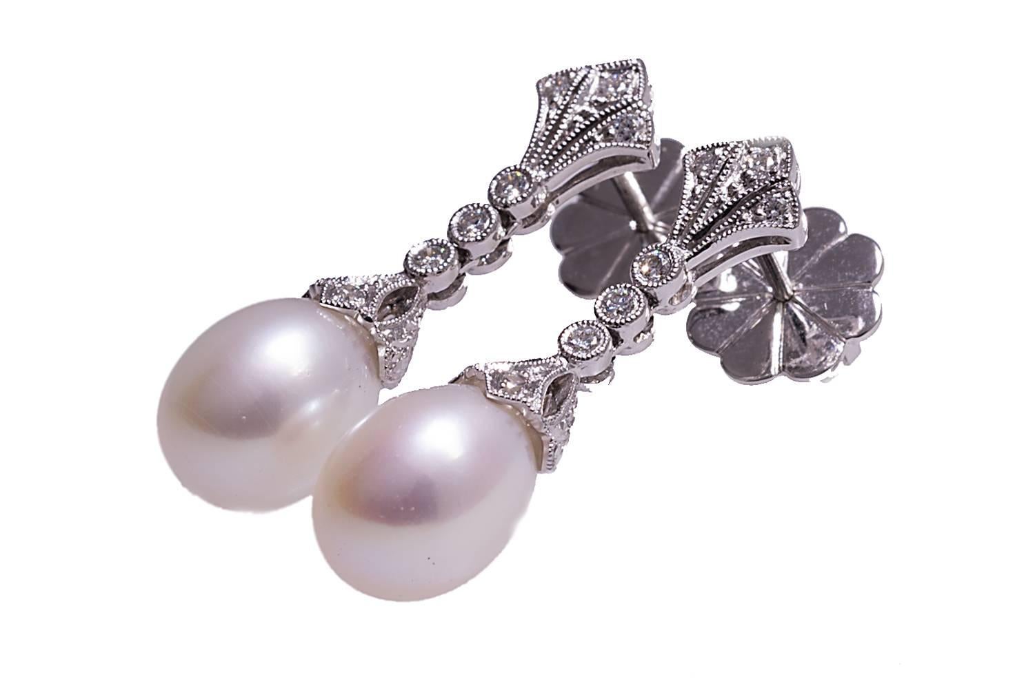 18K antique looking cultured pearl and diamond dangle earrings. The diamonds weigh combined 0.19 carat. 