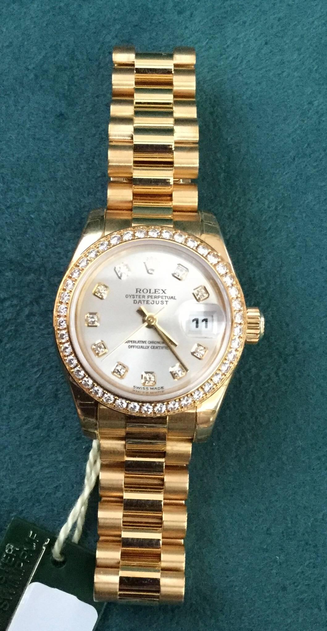 Lady's 18K Rolex Oyster Perpetual Datejust with silvered diamond dial, diamond bezel and President bracelet. NEW. Comes with original Rolex warranty and original box.