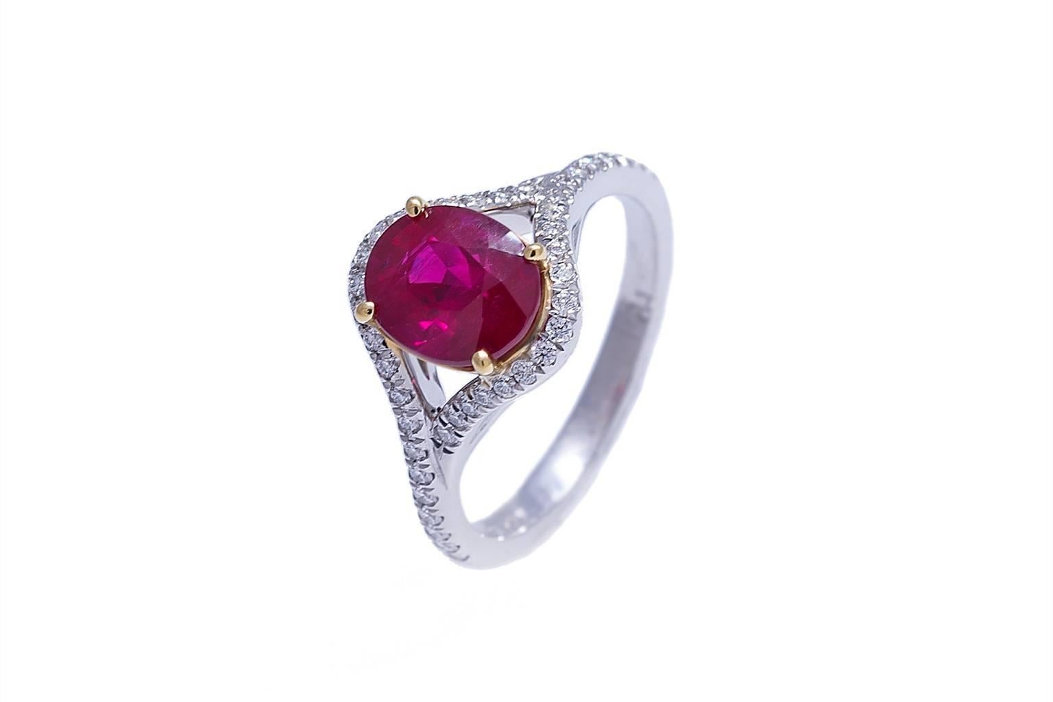 Platinum and 18K ring contains one oval ruby weighing 2.20 carats and forty-two diamonds weighing combined 0.24 carats. Size 6. Can be sized.
