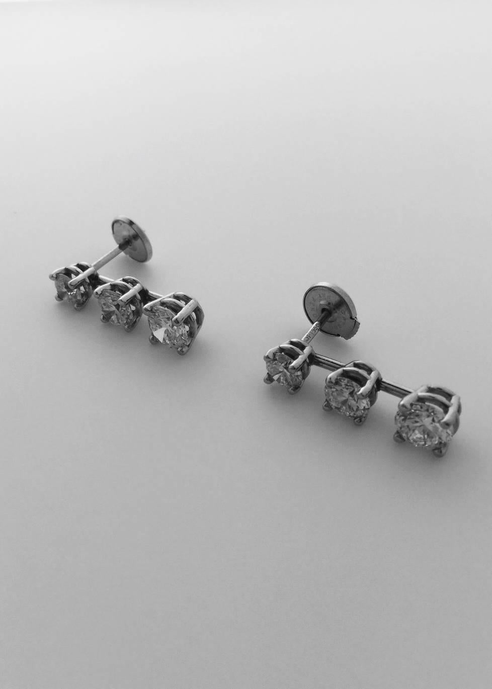 Platinum earrings contains each 3 graduated round brilliant cut diamonds, total 6 diamonds weighing combined 2.15 carats.
2 Diamonds=0.47 carat G-H color/SI1
2 Diamonds=0.72 carat G-H color/SI1
2 Diamonds=0.96 carat G-H color/SI1
Handmade in