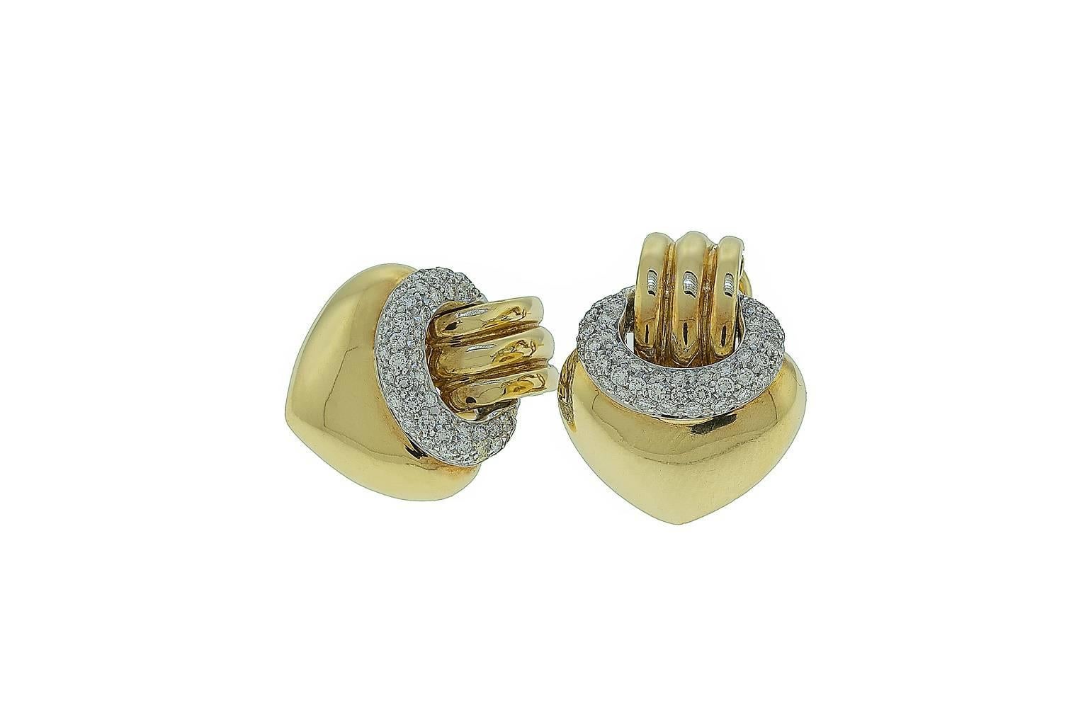 These earrings are an interesting variation of the traditional door knocker earring. Just the right size and the right amount of diamonds to make a statement, they can be worn casual or dressed up. The earrings are 18K yellow gold. The diamonds are