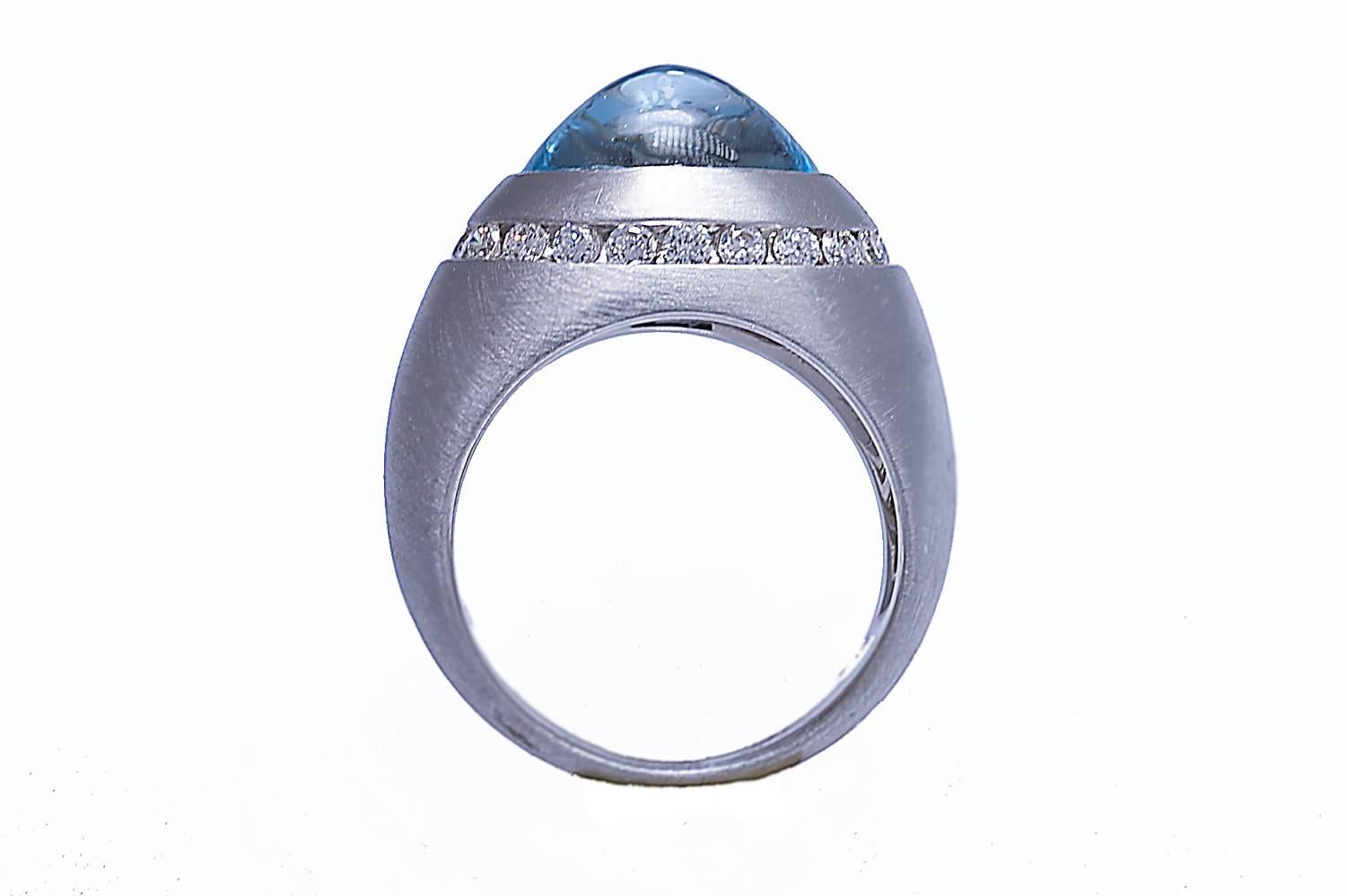18K white gold blue topaz and diamond ring. The blue topaz is a cabochon weighing 5.09 carats. The diamonds weigh combined 0.51 carat. The ring has a satin finish.
The ring can be sized.







