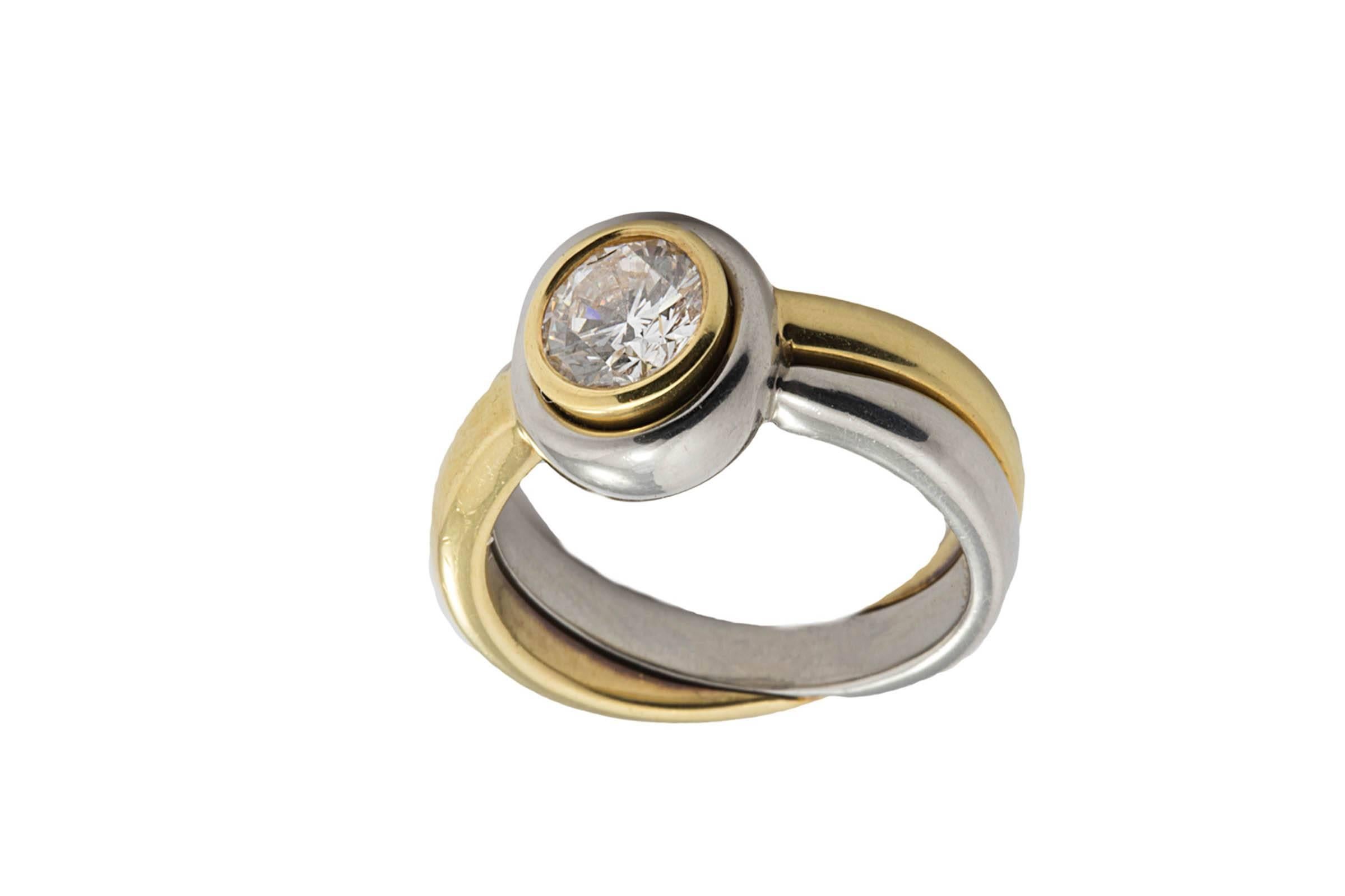 Platinum and 18K gold bezel set diamond ring. The diamond weighs 0.91 carat and G color, SI1 clarity.
This is a very comfortable ring, great for people worried about their diamond 