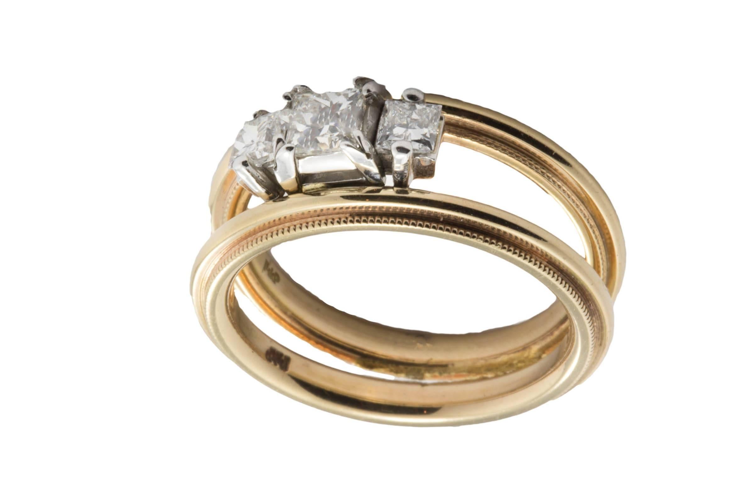 14K rose gold double band contains 3 princess cut diamonds weighing combined 0.67 carat, G color, VS clarity. The diamonds are set in white gold prongs.
Size 6. Can be sized.
