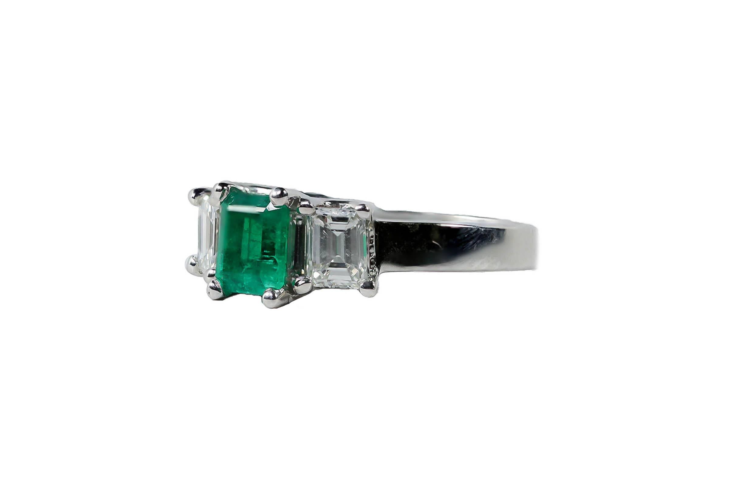 18K white gold ring containing an emerald cut emerald weighing 0.96 carat and two emerald cut diamonds weighing combined 0.96.
Size 6. Can be sized.