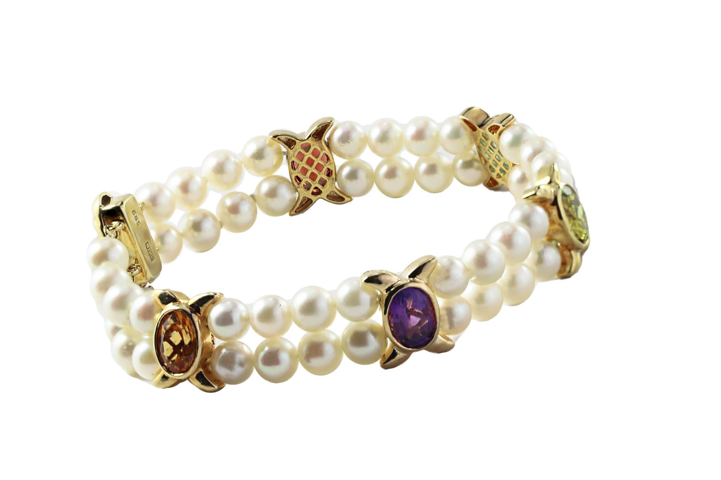 14K yellow gold double strand bracelet with 5mm cultured pearl and bezel set semi-precious stones with diamonds in the clasp.


