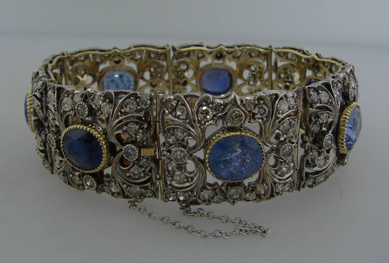 Stunning Victorian bracelet created in Europe in the 1900's. Features seven oval and cushion cut sapphires set in silver and accented with Old European and old mine cut diamonds. The back of the bracelet is made of yellow gold. There are European