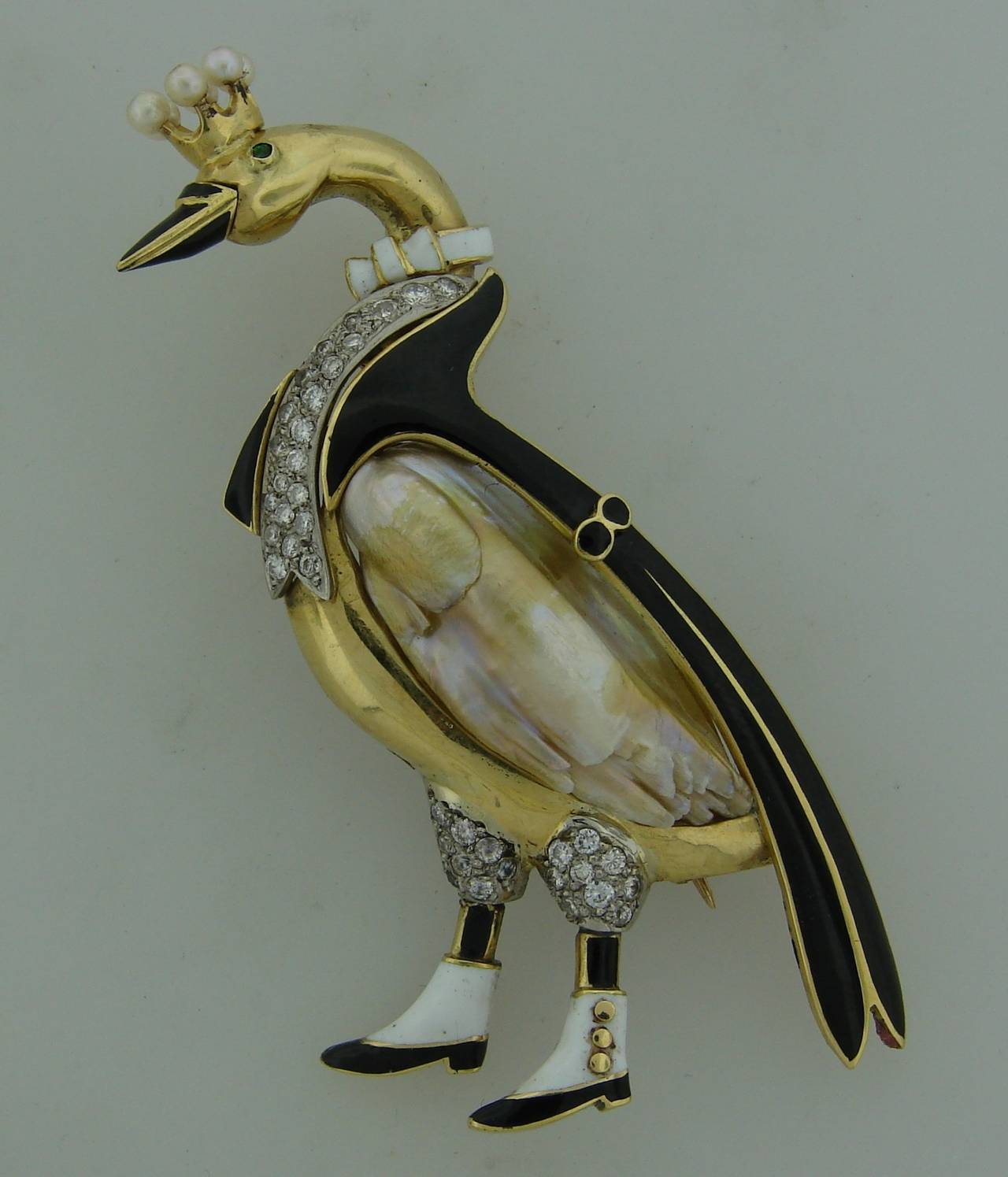 Adorable swan brooch created by J.E. Caldwell in the 1950's! Features an amazing 15.56-ct baroque natural freshwater pearl that eventually inspired the designer to make this brooch. 
The piece is made of 18k (tested) yellow gold and black & white