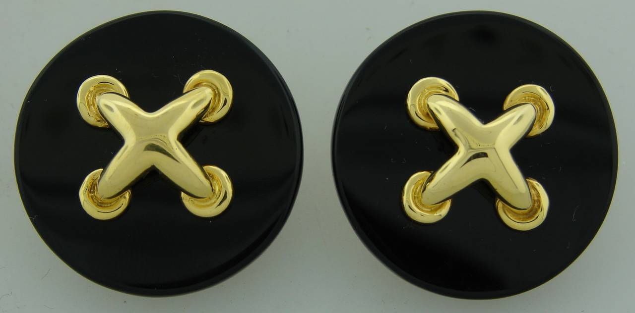 Bold yet elegant earrings created by Aldo Cipullo in 1974. Black onyx circle is accented with yellow gold 