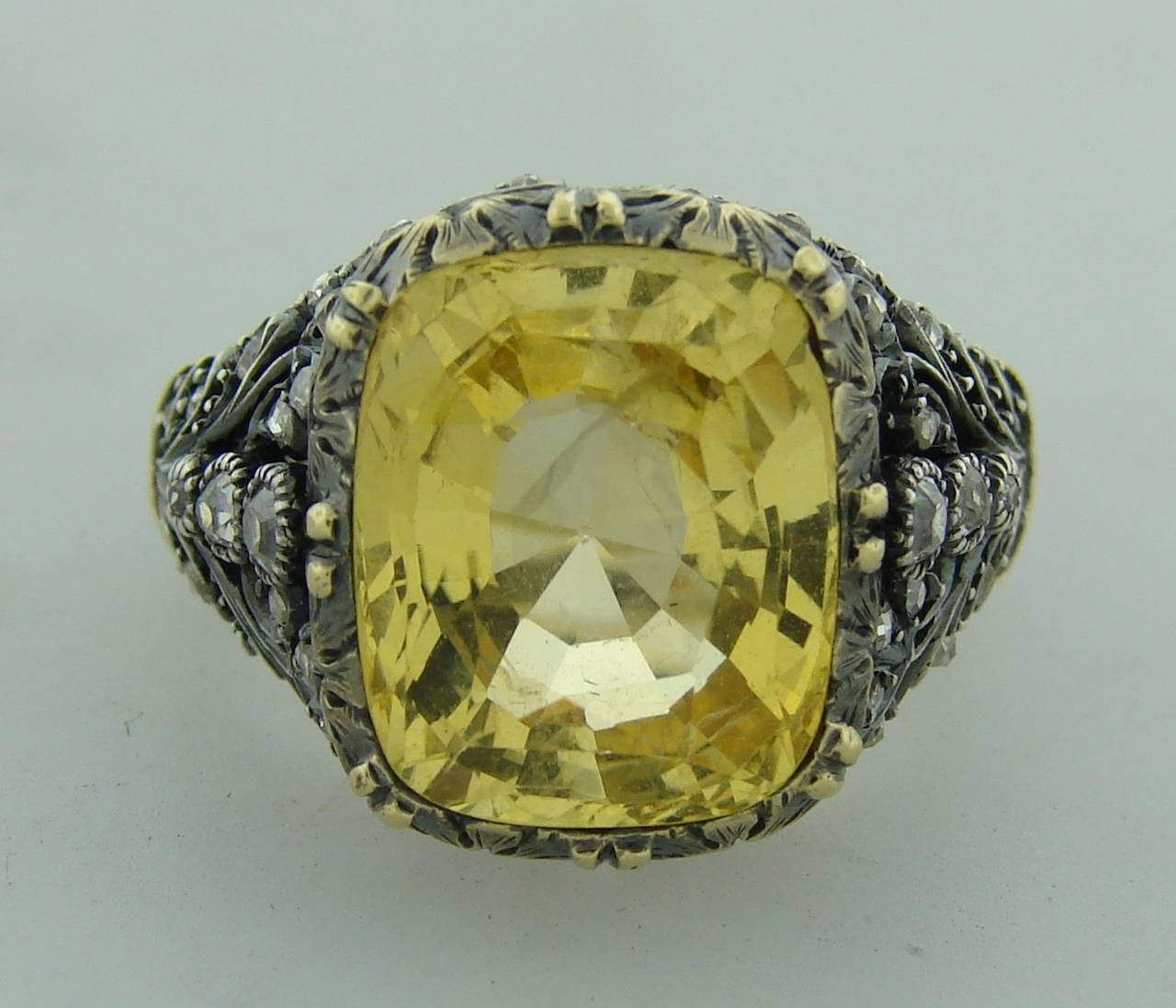 Magnificent cocktail ring created by Mario Buccellati in Italy in the 1950s. 

Features a 10 carat cushion cut yellow sapphire tastefully set in white gold and yellow gold setting and accented with cushion and rose cut diamonds. Amazing meticulous