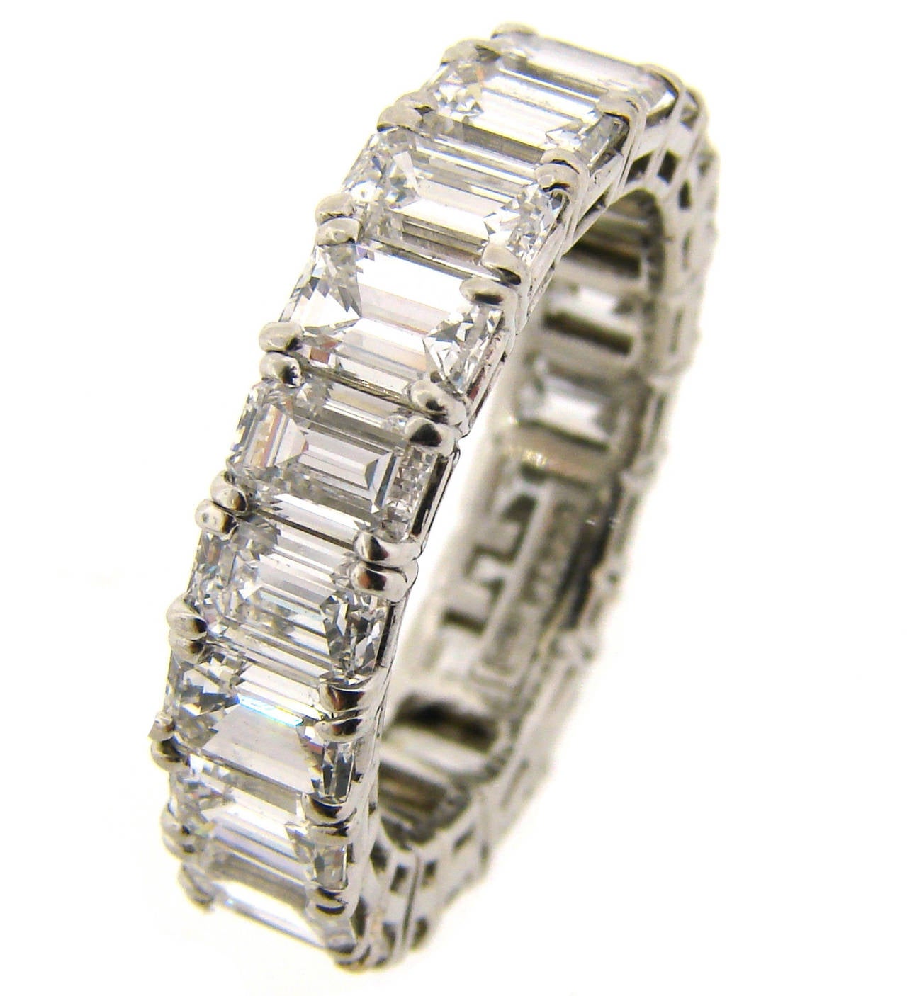 Stunning diamond & platinum eternity band created by a renowned jeweler Harry Winston. Features twenty one emerald cut diamond set in platinum. The diamonds are F-G color, VVS2-VS1 clarity. The diamonds total weight approximately 5.89 carats. The