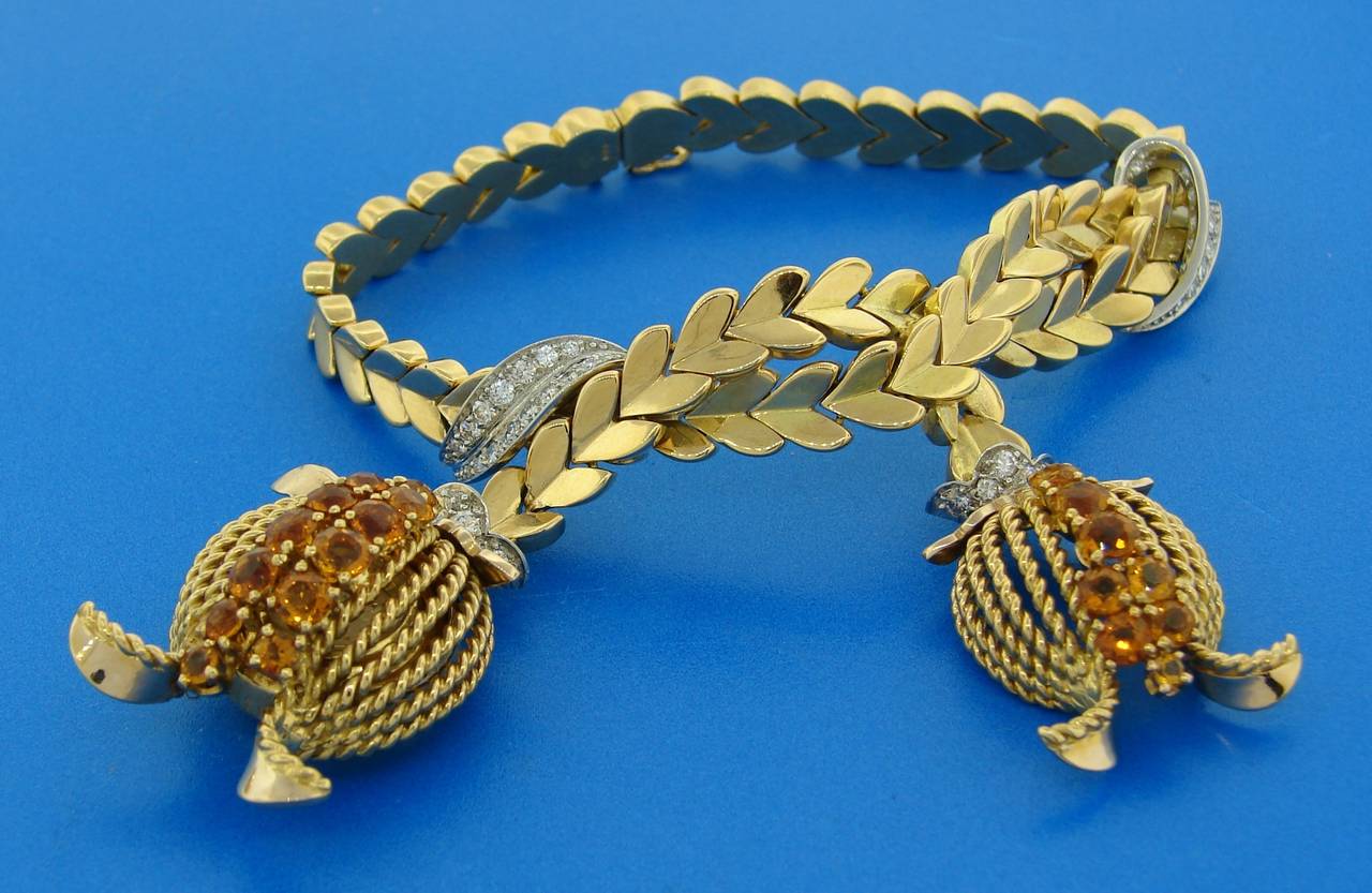 Lovely and fun watch/bracelet created by Omega in the 1950's. Features two charms (one of which is a watch). Made of 18k yellow gold and set with diamonds and citrine. Diamonds are round brilliant cut, total weight approximately 1.02 carats, the