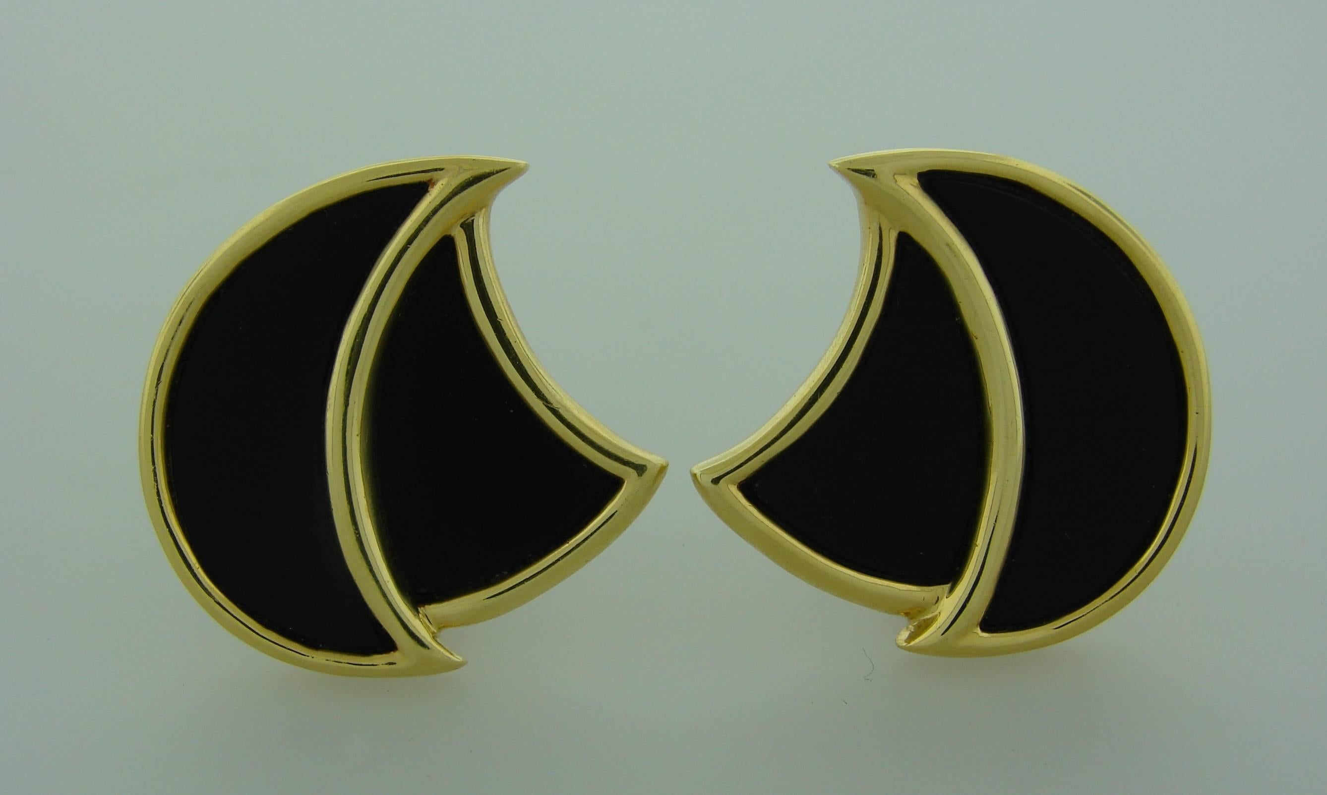 Understated and elegant clip-on earrings created by Henry Dunay in the 1970's. Made of black onyx and 18k (stamped) yellow gold. 
The earrings measure 1-1/8