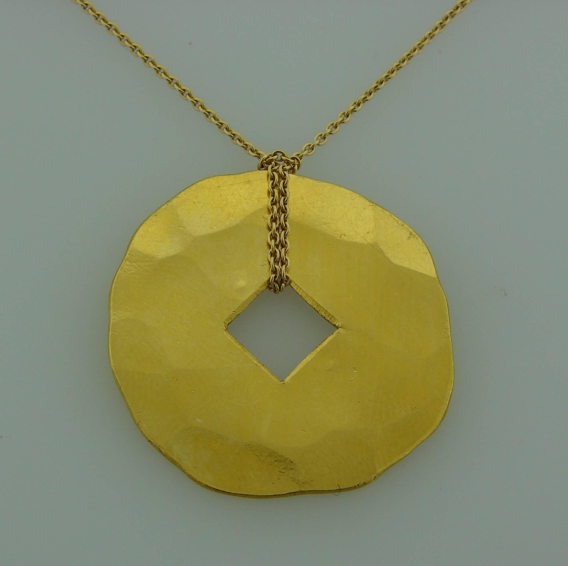 Beautiful hand-hammered yellow gold pendant made of 24k (stamped) yellow gold on 18k (stamped) yellow gold chain. Created by Dinh Van. 
The pendant is in average 1.25