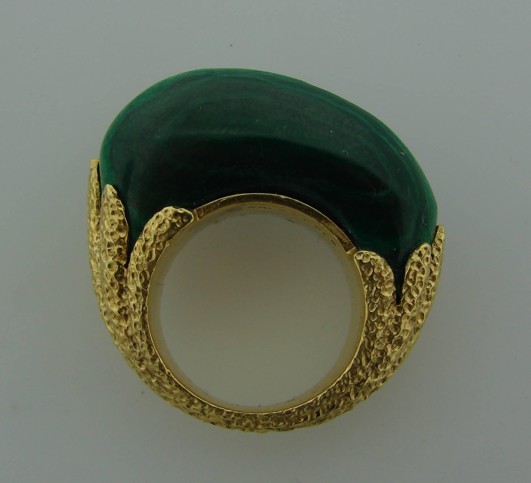 Bold and colorful cocktail ring created by Van Cleef & Arpels in the 1970's. Made of 18k (tested) yellow gold and malachite. Beautiful color combination. Size 5.5. 
Can make a statement as a pinky ring. 
The malachite measures 1" x