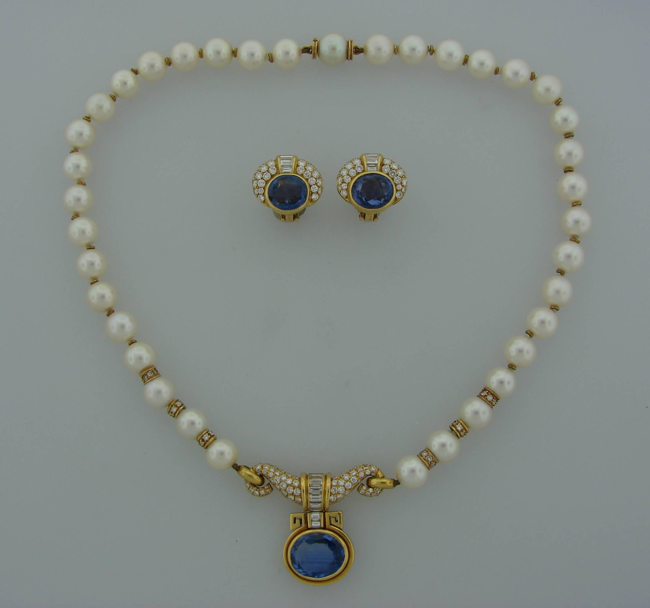 Elegant and timeless set consisting of a necklace and a pair of earrings. Created by Bulgari in Italy in the 1980's. Features thirty seven Akoya pearls, oval faceted blue sapphires set in 18k yellow gold and accented with round brilliant and