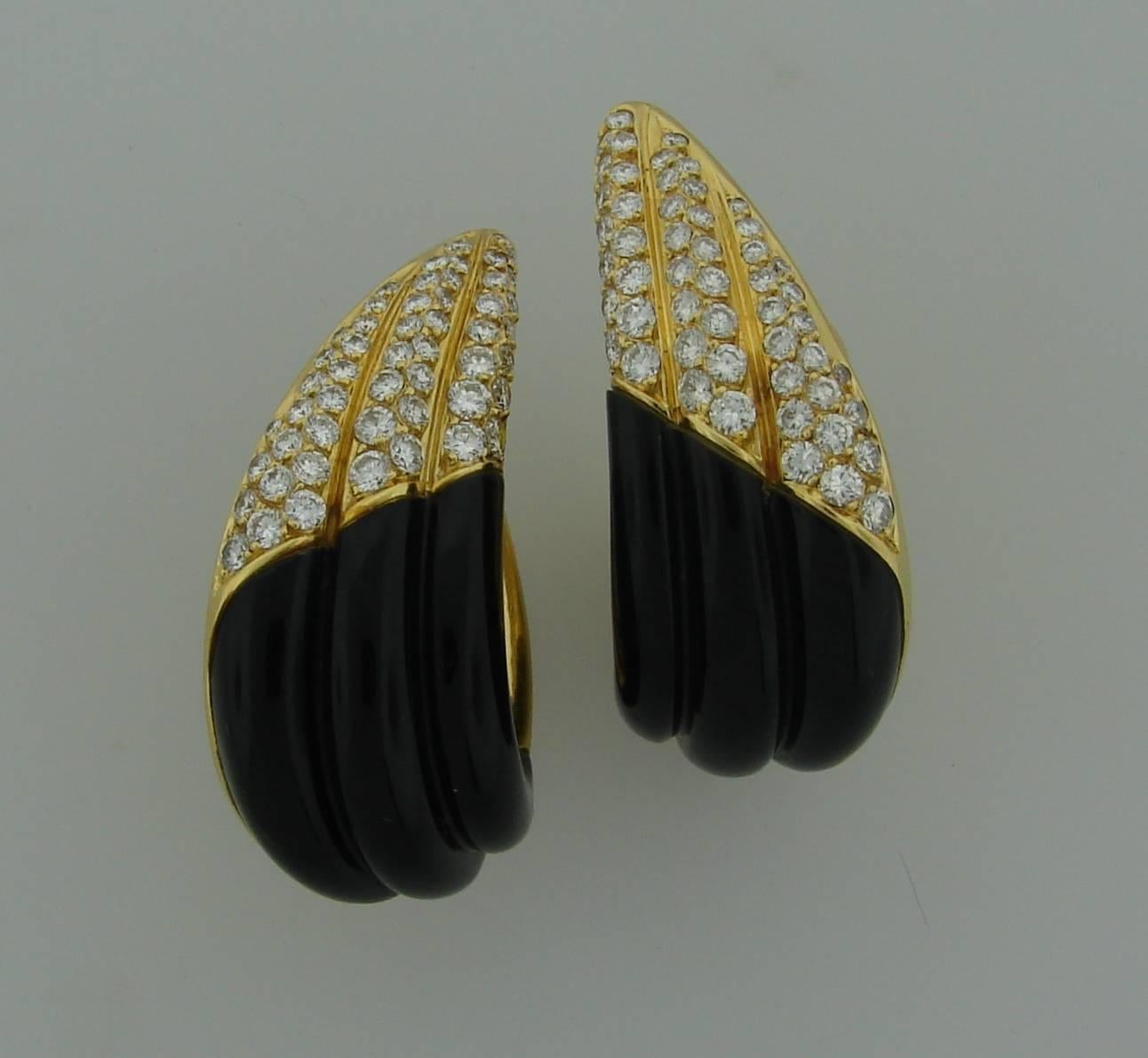 Stunning earrings created by Fred in Paris in the 1980's. Made of black onyx and 18k (stamped) yellow gold encrusted with one hundred four round brilliant cut diamonds (total weight is approximately 3.52 carats). The diamonds are of F-G color and