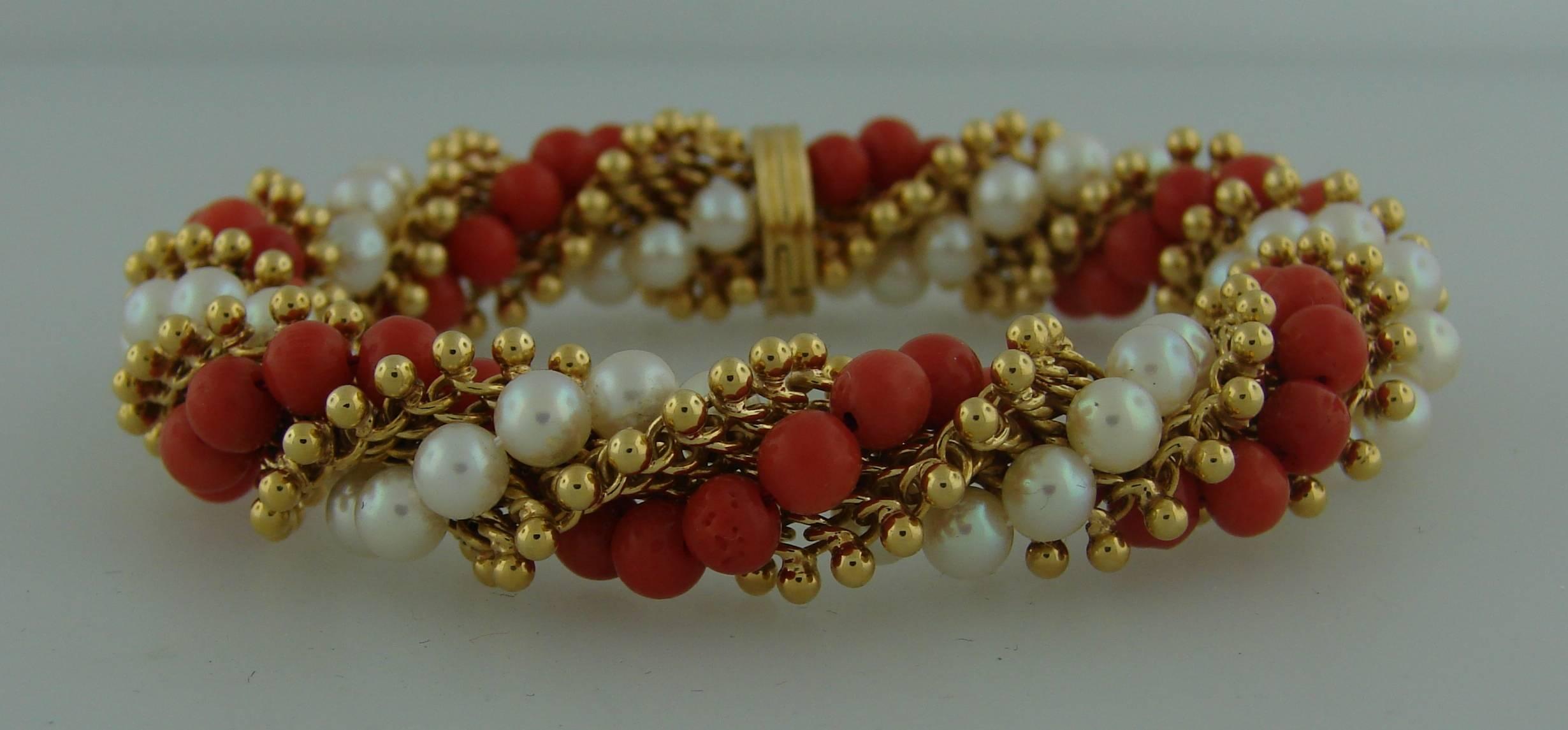 Chic and colorful bracelet created by Van Cleef & Arpels in France in the 1970s. Features a strand of pearls and a strand of coral beads embedded in 18k yellow gold mesh. 
The bracelet is 1/2