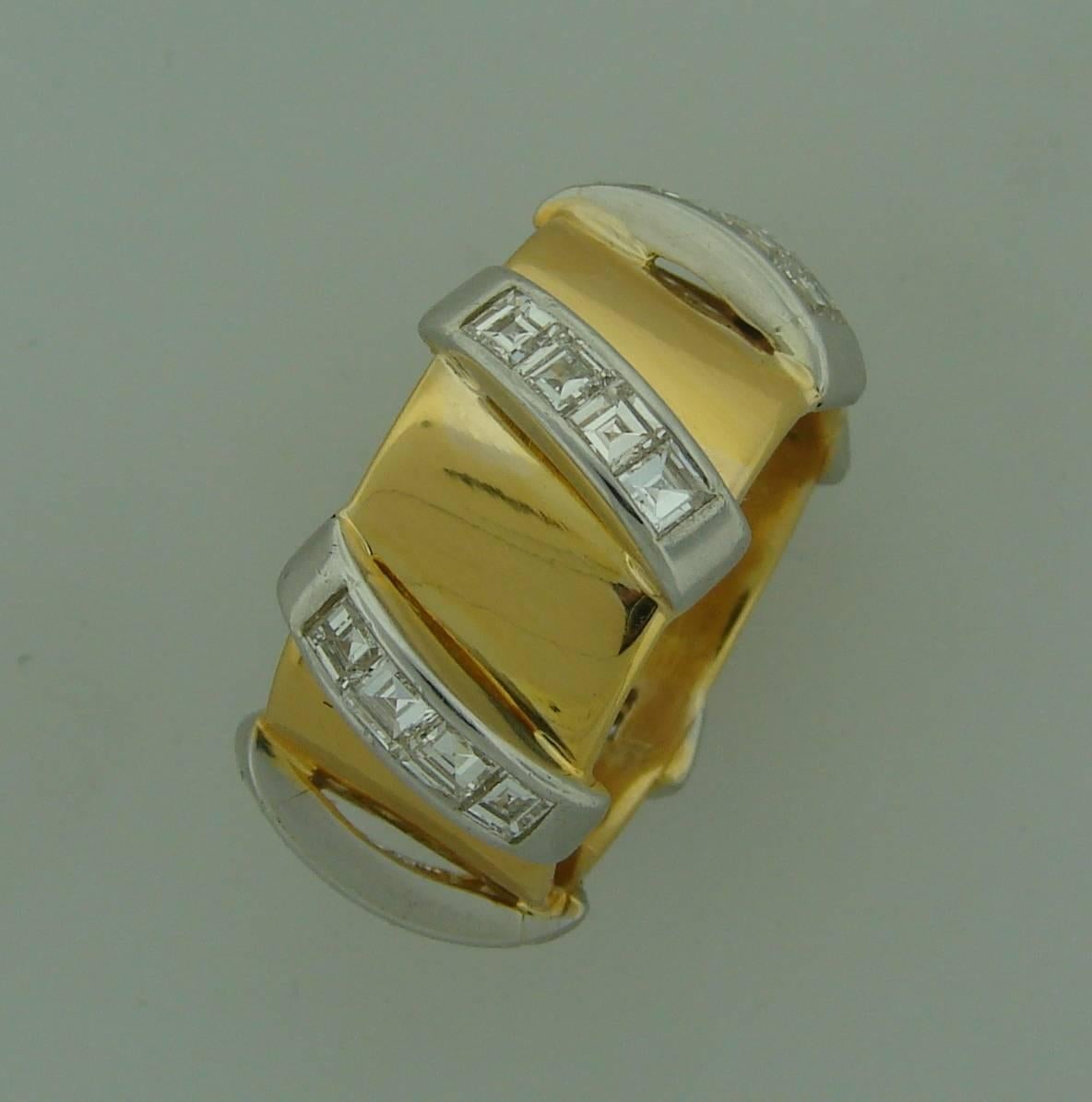 Bold yet elegant band ring created by Seaman Schepps in the 1980s. Beautiful highly polished yellow gold shank crossed over with six diamond bars gives the band modernist and stylish look and boldness. 
The ring is made of 18 karat (tested) yellow