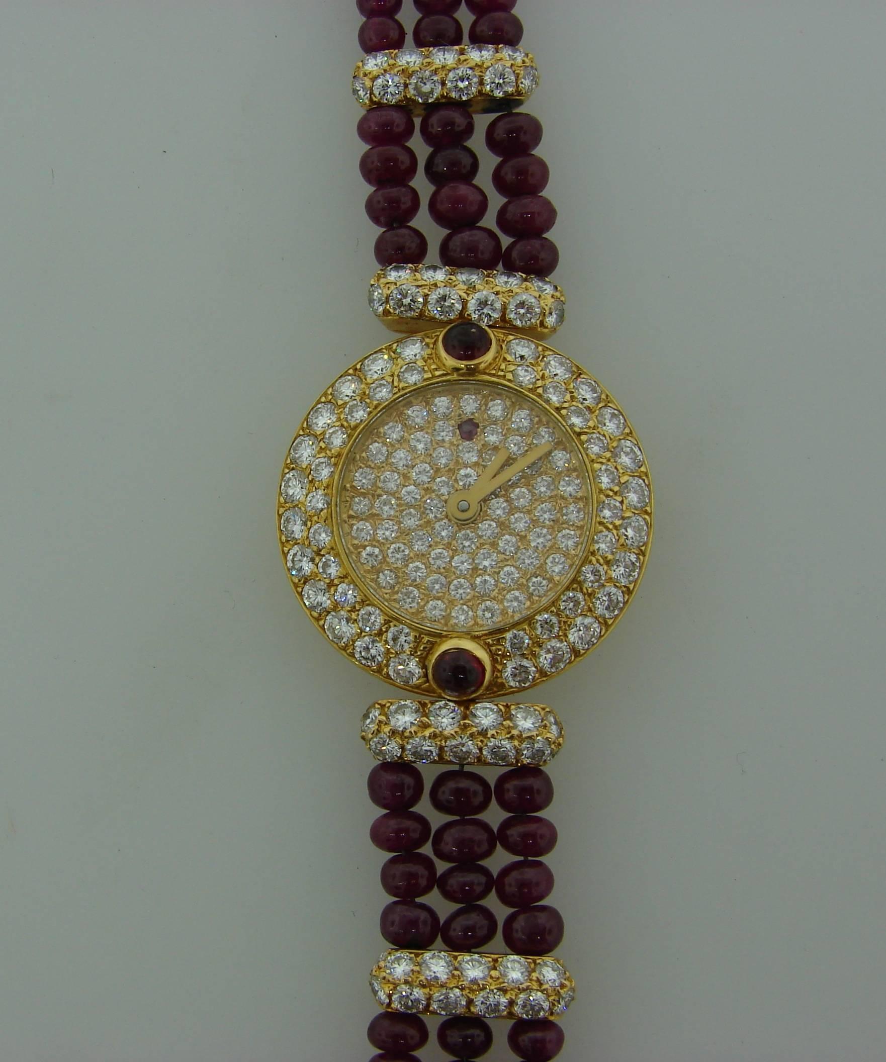 Elegant lady's watch made of 18 karat (stamped) yellow gold. The watch face is encrusted with round brilliant cut diamonds and the bracelet is made of ruby beads and diamonds. 
Quartz movement.
Face is 24.5 mm (1 inch) in diameter, the bracelet is