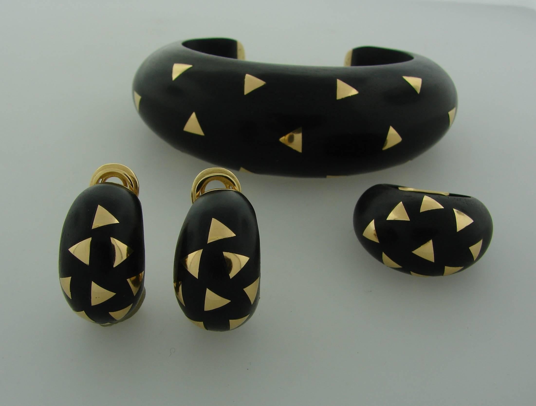 Chic and stylish set created by Van Cleef & Arpels in France in the 1970's. It consists of a bangle, a ring and a pair of earrings and is made of ebony wood and 18 karat (stamped) yellow gold. It will be a great addition to your collection. Elegant