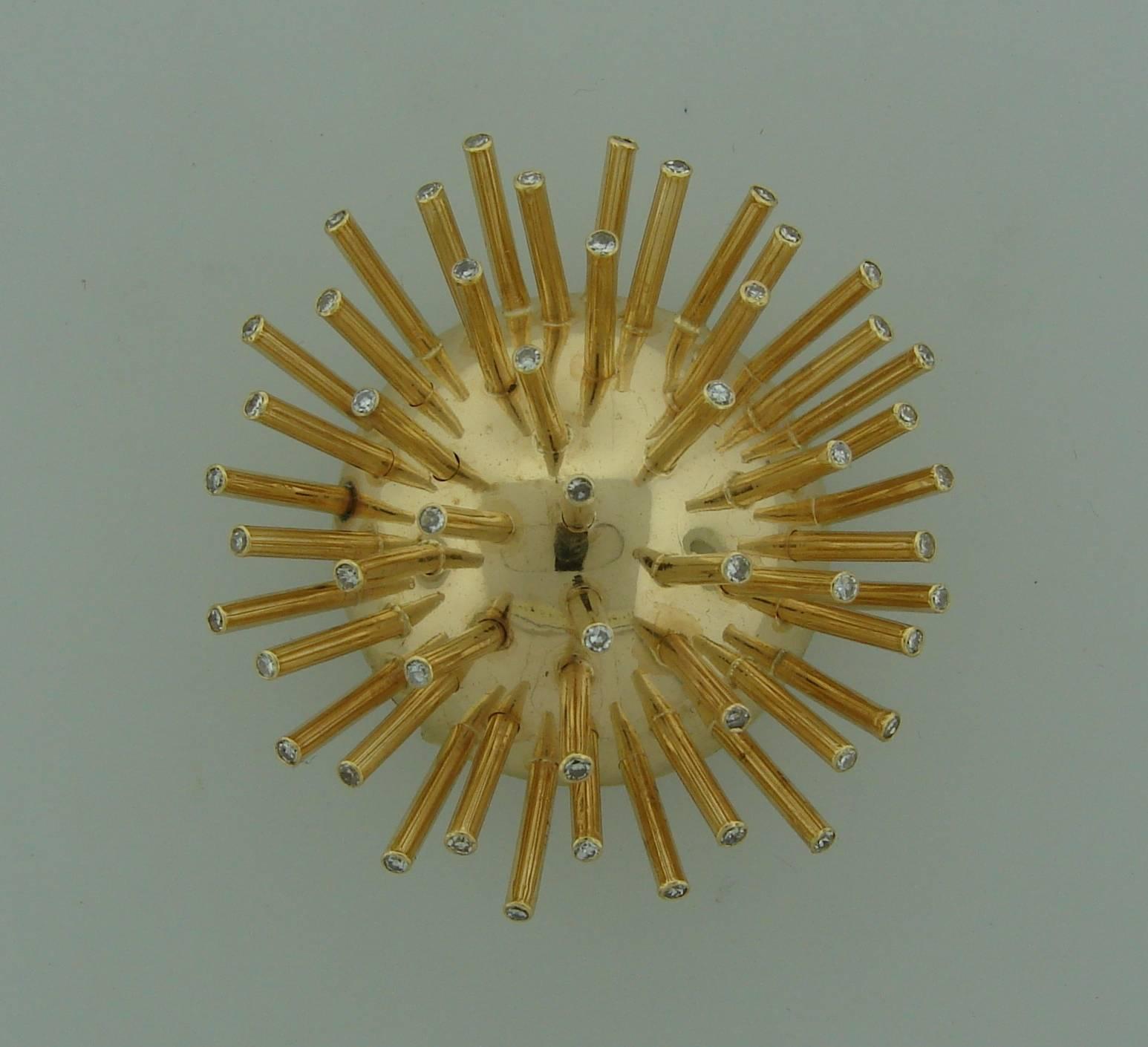 Elegant and fun Sputnik clip created by Cartier in the 1950's. Makes a chic accent to any outfit and is a great addition to your jewelry collection.
It is made of 14 karat yellow gold and single cut diamonds (total weight approximately 0.47 carat).
