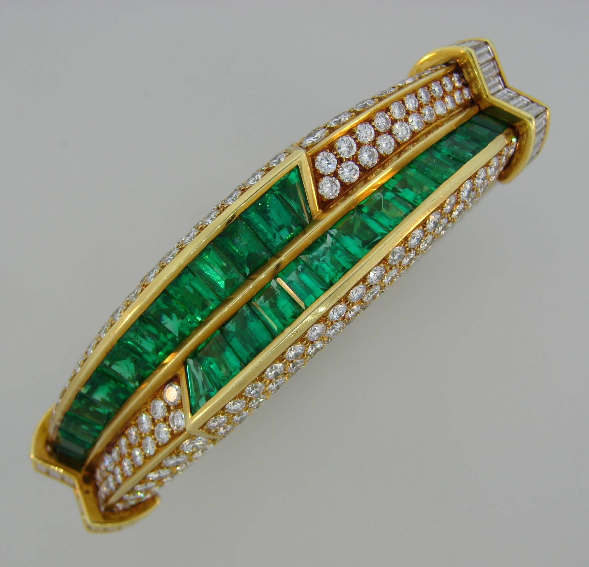 Magnificent bangle bracelet created by Harry Winston in the 1990's. Gorgeous green sparkle of emeralds is emphasized by dazzling brilliance of the diamonds and yellow gold setting creates elegantly dramatic look. The bracelet is definitely a