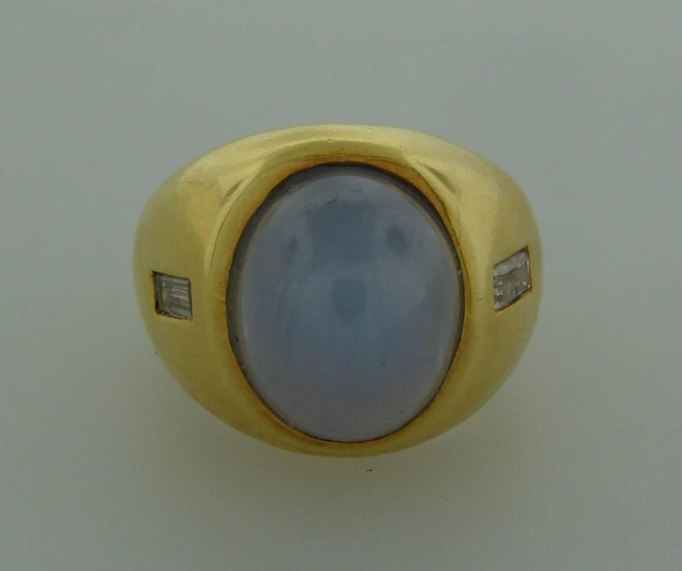 Elegant and timeless cocktail ring created by Andrew Clunn in the 1970's. 
Classic design, beautiful color combination, mysterious star sapphire set in yellow gold and subtle sparkle of two diamonds are the highlights of this stylish ring.  Makes a