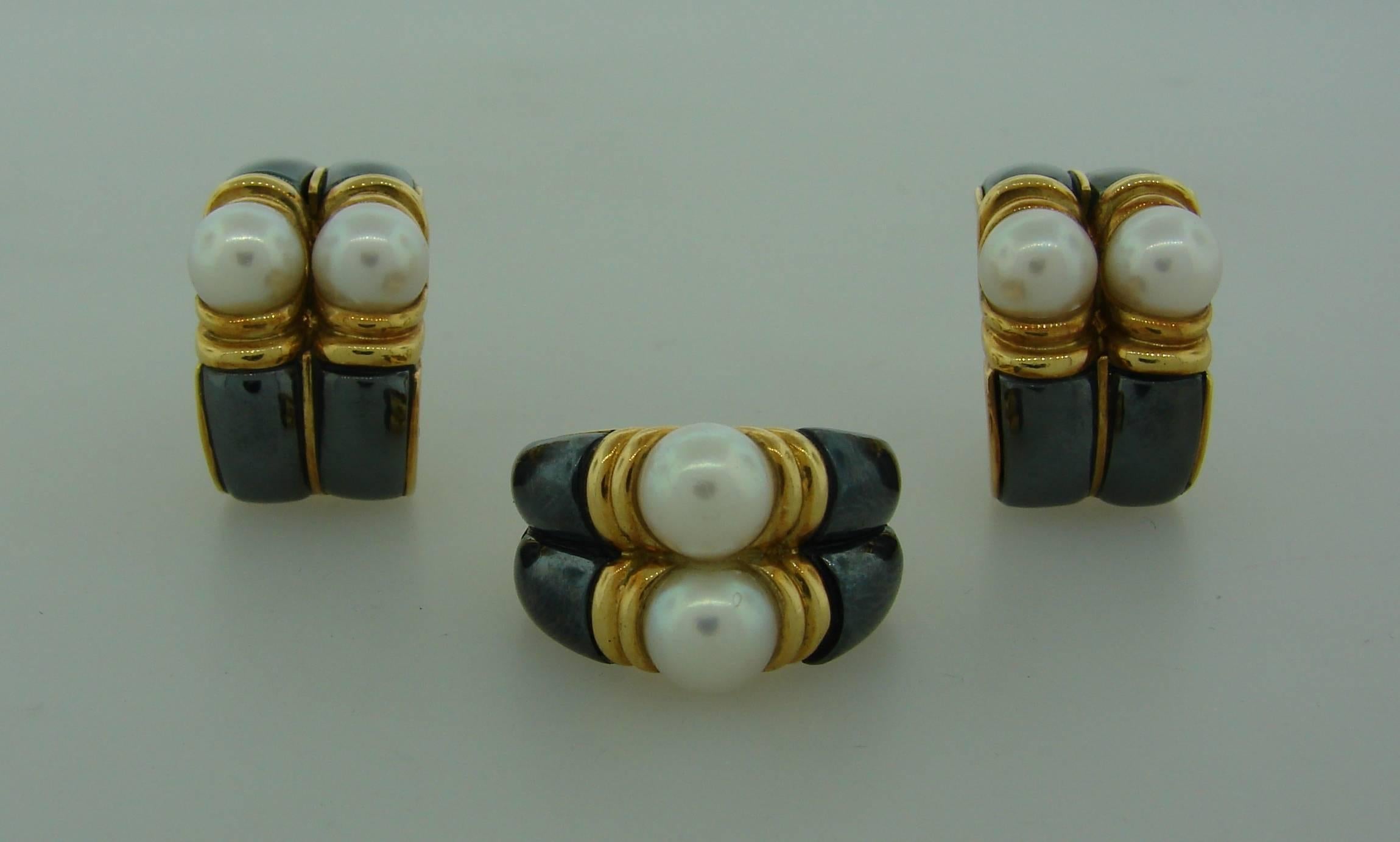 Elegant and chic set consisting of a ring and a pair of earrings. Created by Bulgari in Italy in the 1980's. The set in made of 18 karat (stamped) yellow gold, hematite and Akoya pearls. Both, the pearls and the hematite, have this mysterious luster