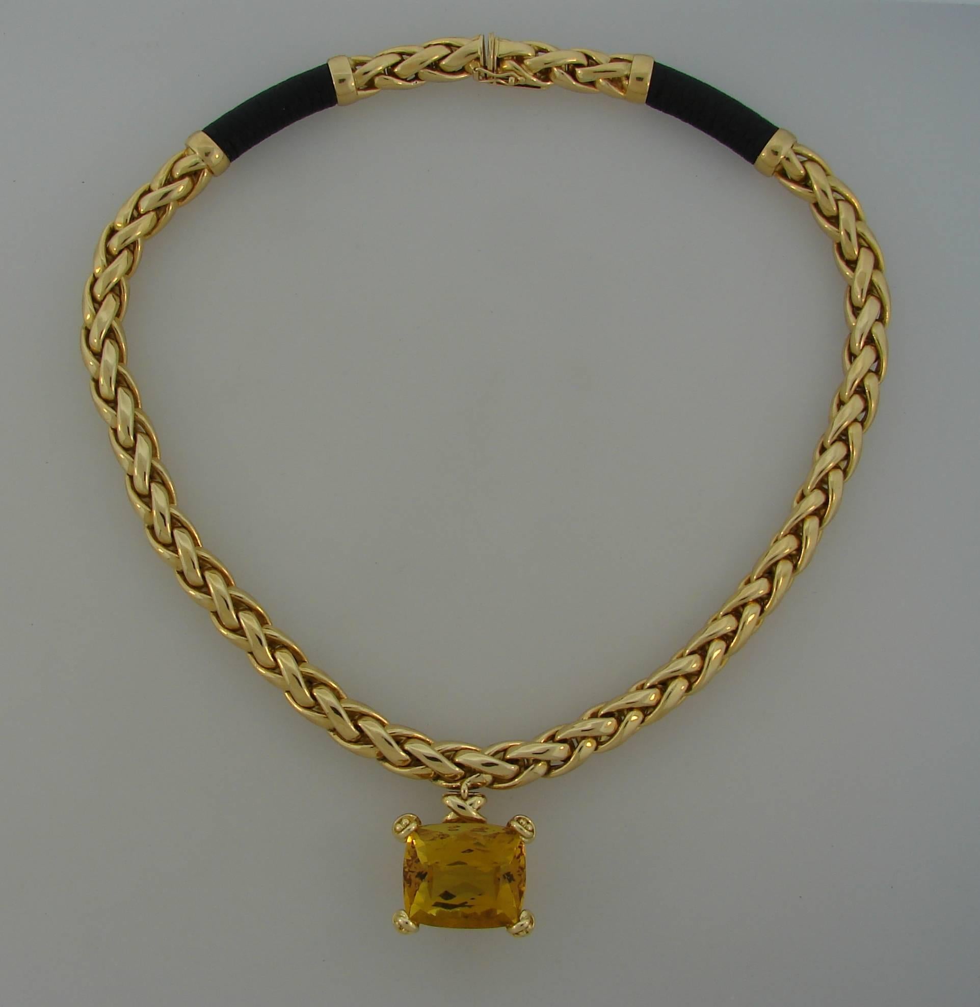 Bold, colorful, elegant necklace created in Italy for Tiffany & Co. by Paloma Picasso. Features a beautiful sunshine citrine that is cut in cushion shape. Yellow gold woven necklace has two black leather insertions which together with impressive