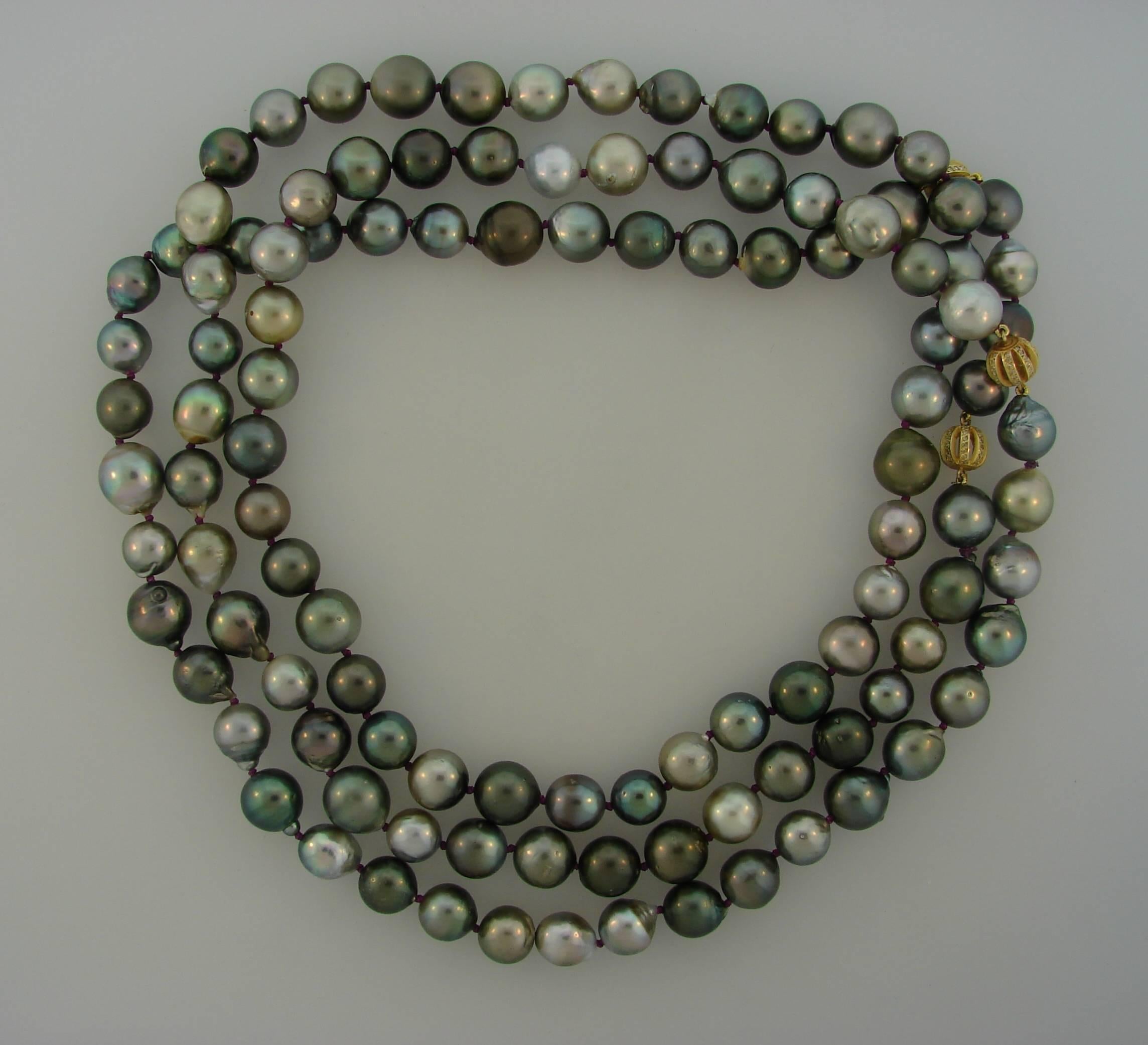 Chic and versatile Tahitian pearl necklace created by L. Frank. It can lay as one long strand or turn once or twice around a neck. The pearls come in all shades of gray and some of them have warm golden hue. There are three diamond & yellow gold
