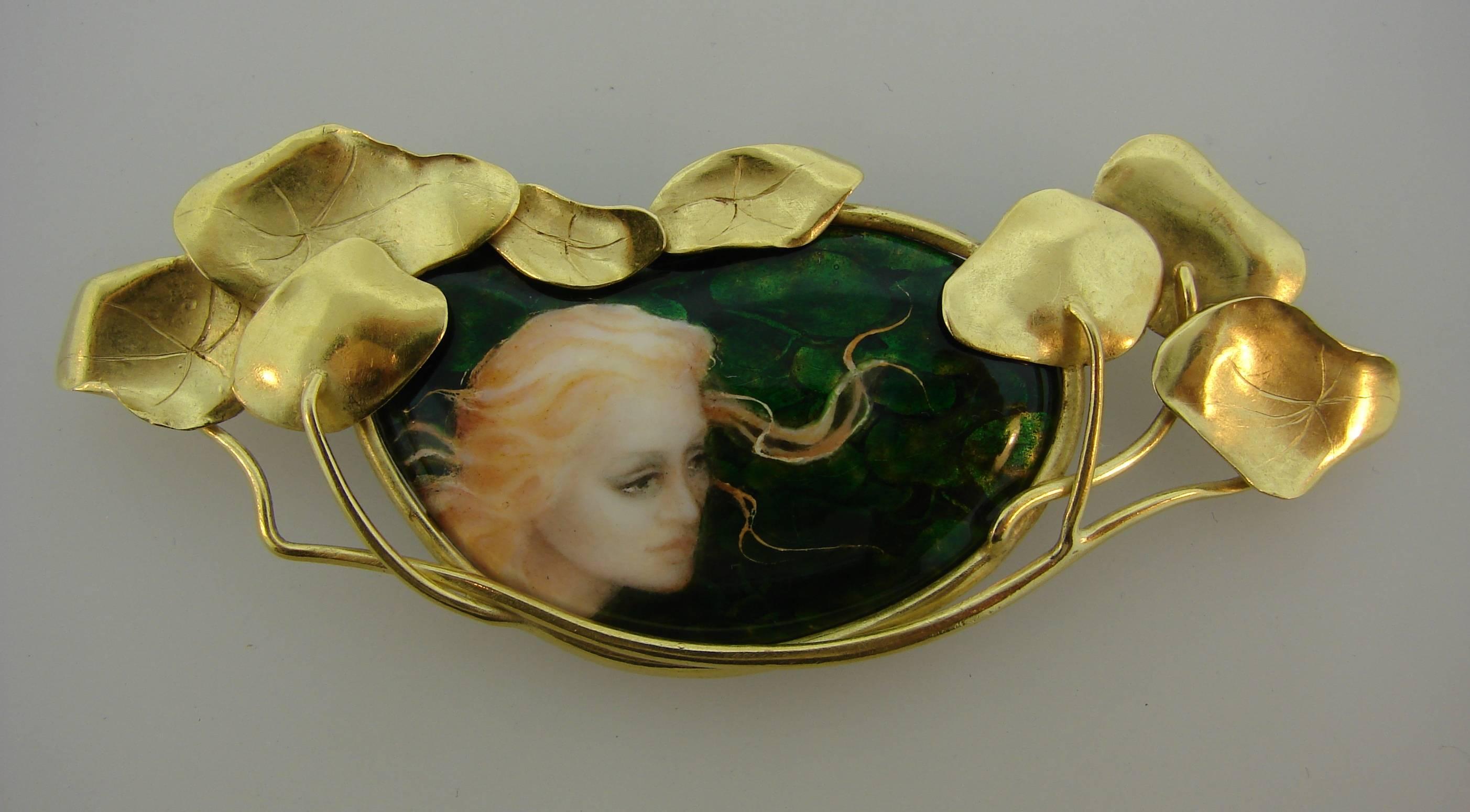 Gorgeous Art Nouveau Revival brooch created by an artist Larissa Podgoretz who often finds her inspiration in a face or gesture that has the purity of line and color. 
The brooch is made by hand of 18 karat yellow gold and beautiful Lemoges style