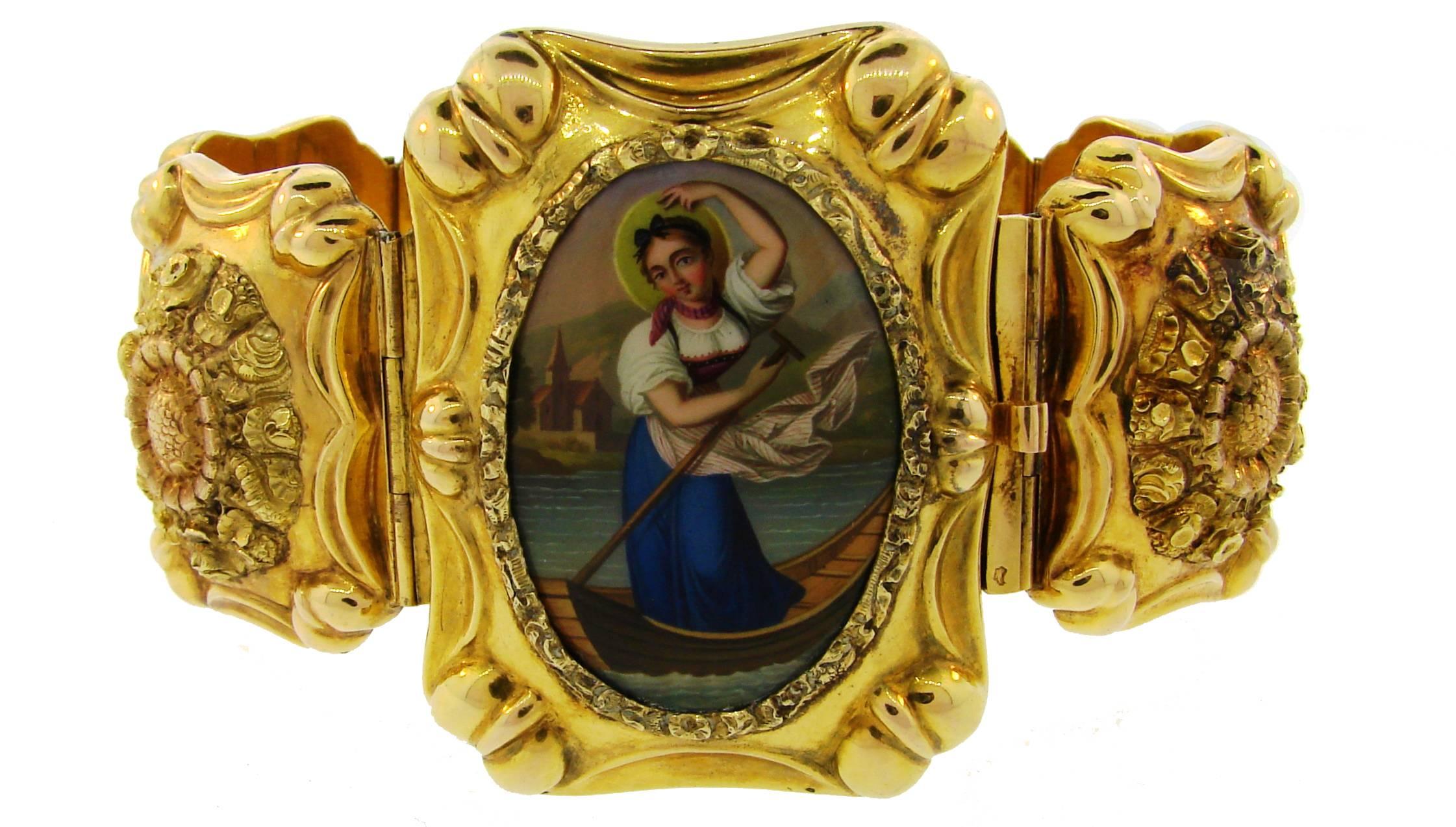 Fantastic Victorian bracelet created in France in the 1900's. Features six golden medallions with beautiful detailed floral gold work and one with a hand-painted enamel depicting a young woman in a boat. 
The bracelet is very three-dimensional and