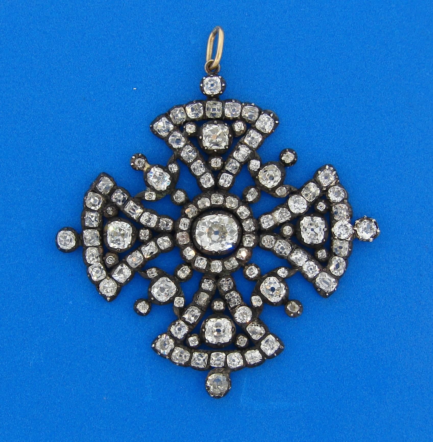 Beautiful Georgian diamond Maltese cross pendant that is a perfect gift for the holidays. It is made of silver and 14 karat (tested) yellow gold and set with old mine cut diamonds. Center diamond is approximately 1.23 carats, diamond total weight is