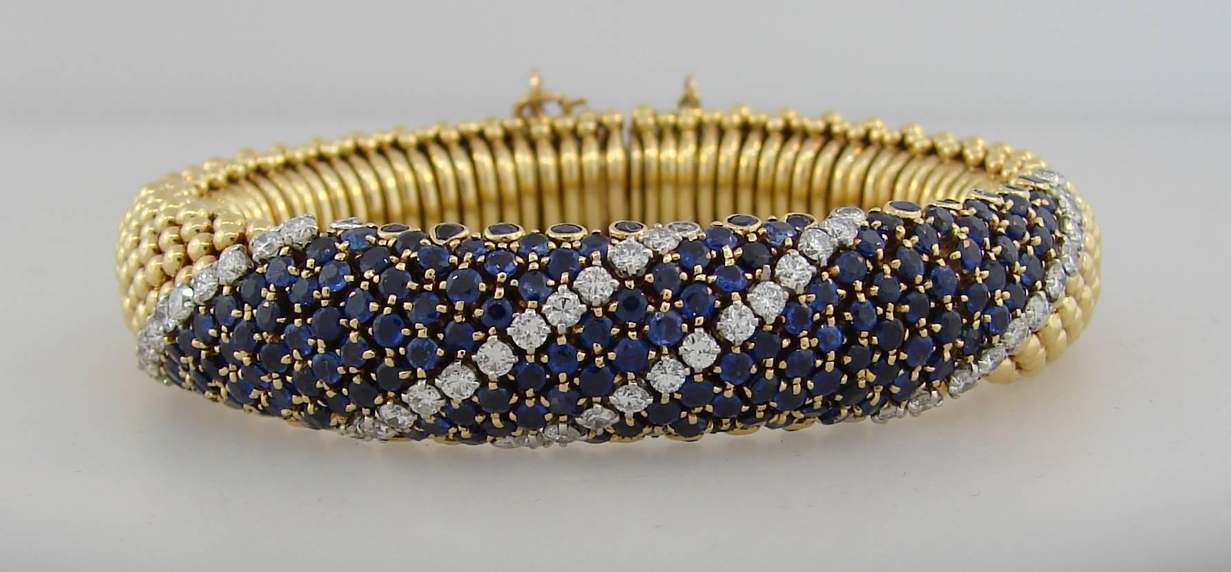 Classy and feminine bracelet created by Van Cleef & Arpels in New York in the 1950's. Tasteful color combination of yellow gold and blue sapphire accented with sparkly diamonds, volume, outstanding workmanship make the bracelet  elegant, stylish