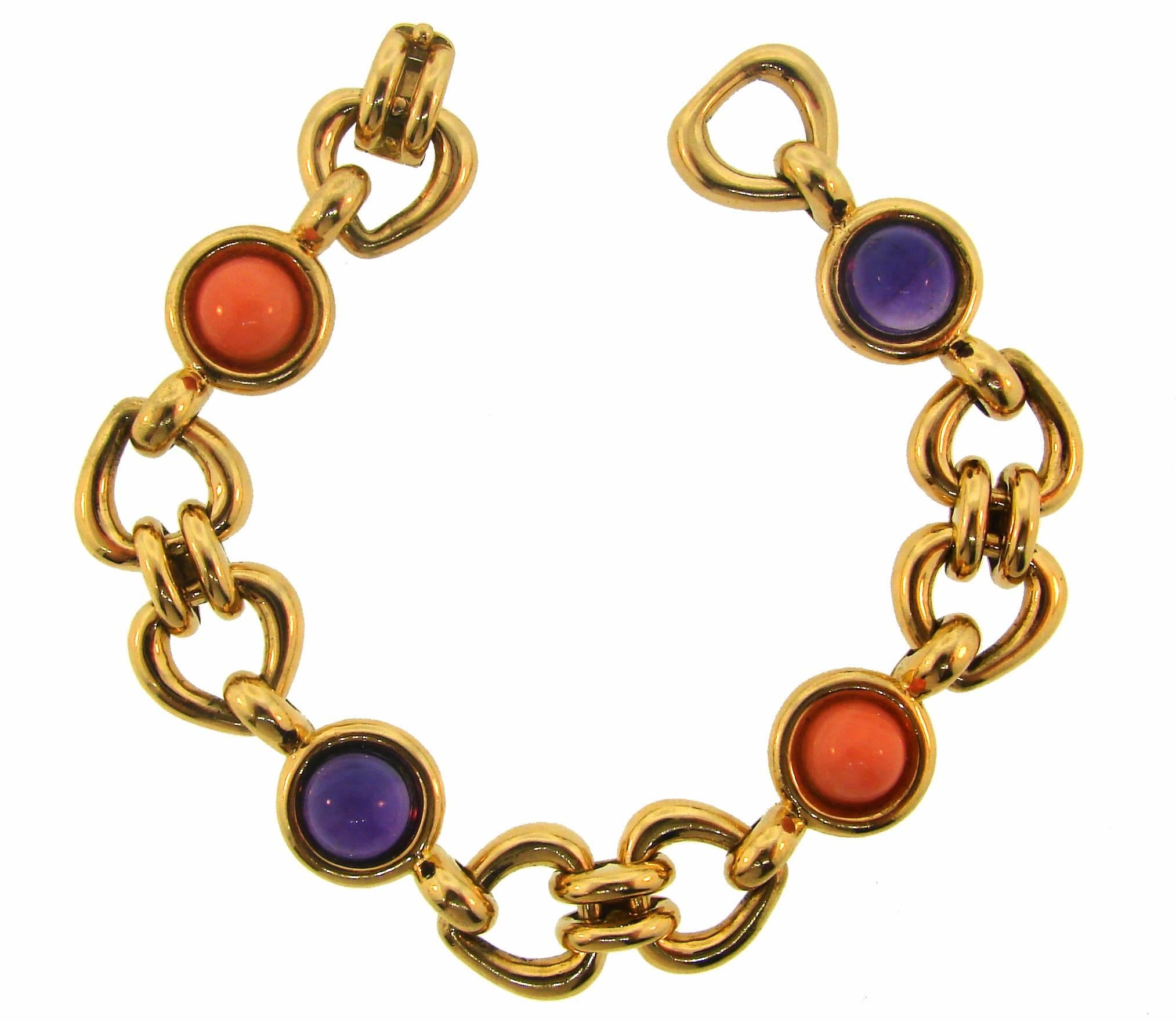 Colorful elegant bracelet created by Van Cleef & Arpels in France. Stylish and wearable, it is a great addition to your jewelry collection. 
It is made of 18 karat yellow gold and set with two cabochon corals and two cabochon amethysts. 
The