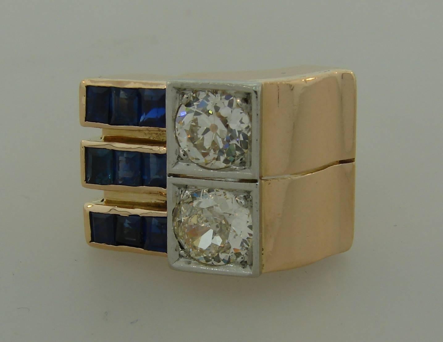 Bold and smart retro ring created in the 1940s. It features two Old European cut diamonds accented to one side with three rows of pre-cut table cut sapphires. The diamonds are approximately 0.98-carat (K color, VS2 clarity) and 1.10-carat (M color,