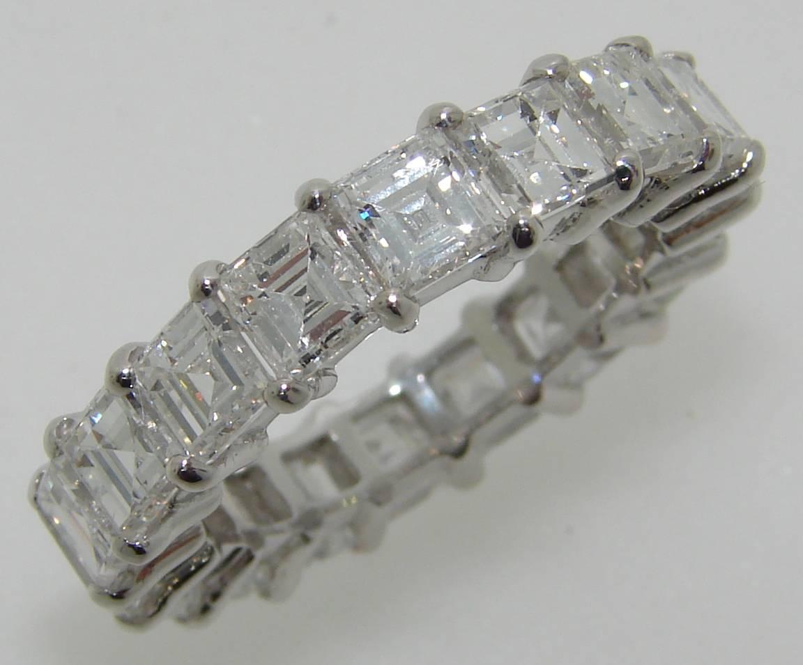 Chic and sparkly diamond eternity band. Eighteen beautiful and perfectly matching square step cut diamonds are set in 14 karat white gold. The diamonds are G-H color, VS1 clarity, total weight approximately 5.94 carats.
The band is 3.77 mm wide, is