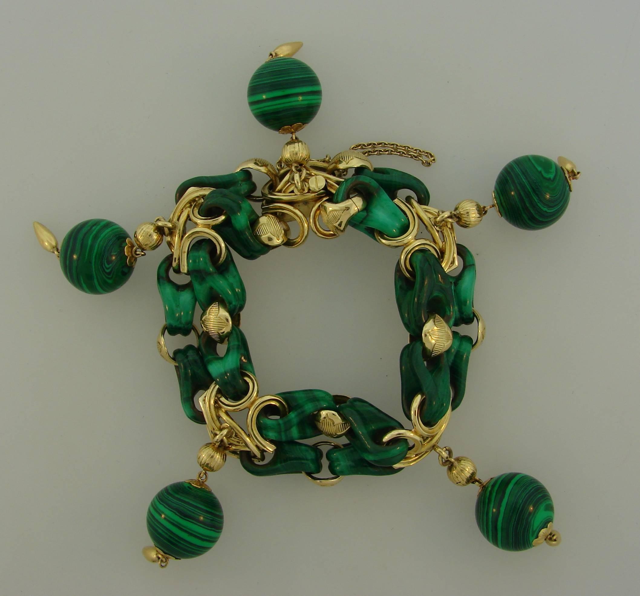 Chic and colorful bracelet created in France in the 1970's. Wearable and fun, it is a great addition to your jewelry collection. 
The bracelet is made of 18 karat yellow gold and malachite. The malachite is skillfully carved to create these unique