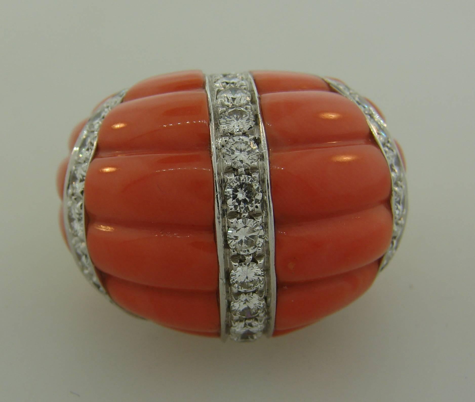 Bold and colorful cocktail ring created by David Webb in the 1970s. It is made of 18 karat yellow gold and beautifully carved Mediterranean coral accentuated with round brilliant cut diamonds. The diamonds are F-G color, VVS2 clarity, total weight