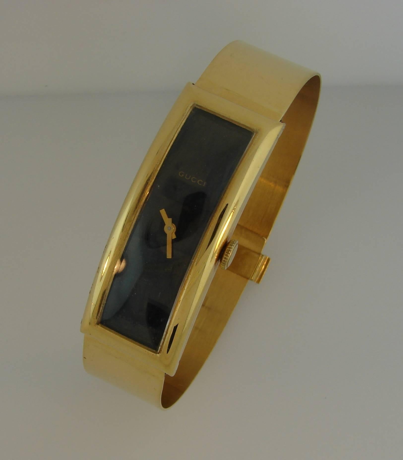 Stylish and elegant gold watch that is a great addition to your collection. It was created by Gucci in the 1970s. 
The watch and the bracelet are made of 18 karat yellow gold. 
The movement is mechanical, manual wind.
The face measures 2 x 3/4 inch