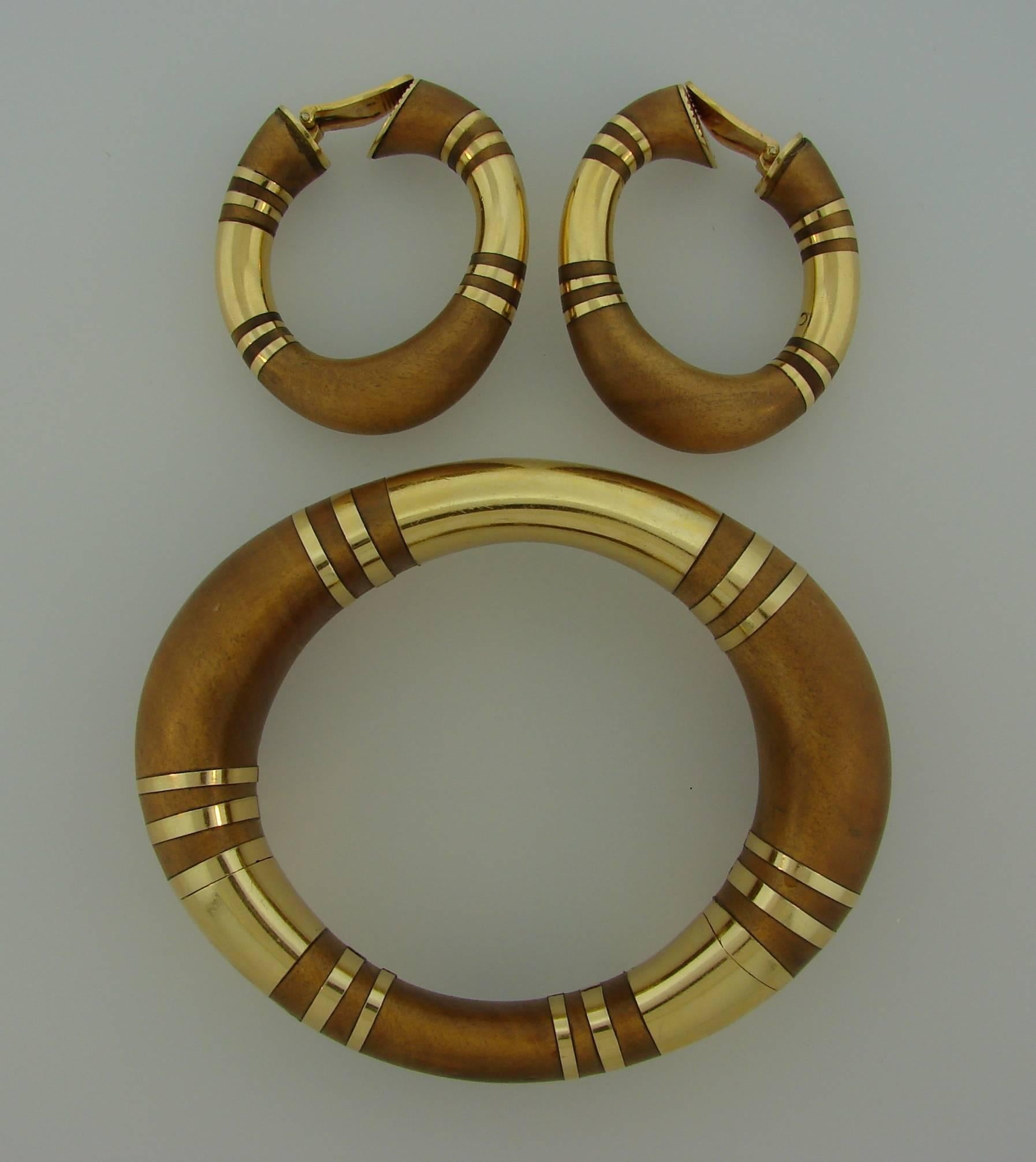 Bold yet elegant set consisting of a bangle bracelet and a pair of earrings. Created by Rene Boivin in France. Perfect proportions, beautiful curves and organic combination of wood and gold are the highlights of this gorgeous set. Chic and