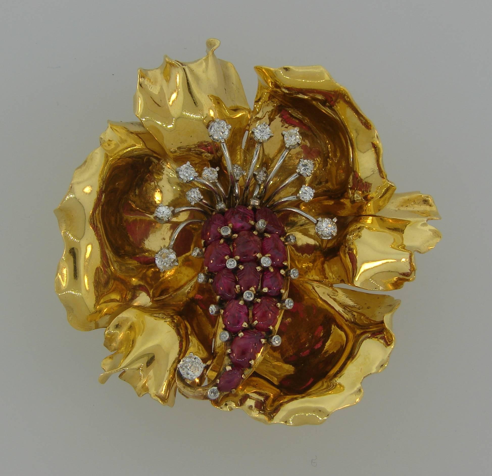 Gorgeous three-dimensional flower clip. Chic accent to any outfit, the brooch is a great addition to your jewelry collection. 
Made of 18 karat (stamped) yellow gold and set with thirteen carved rubies and accented with thirty Old European cut