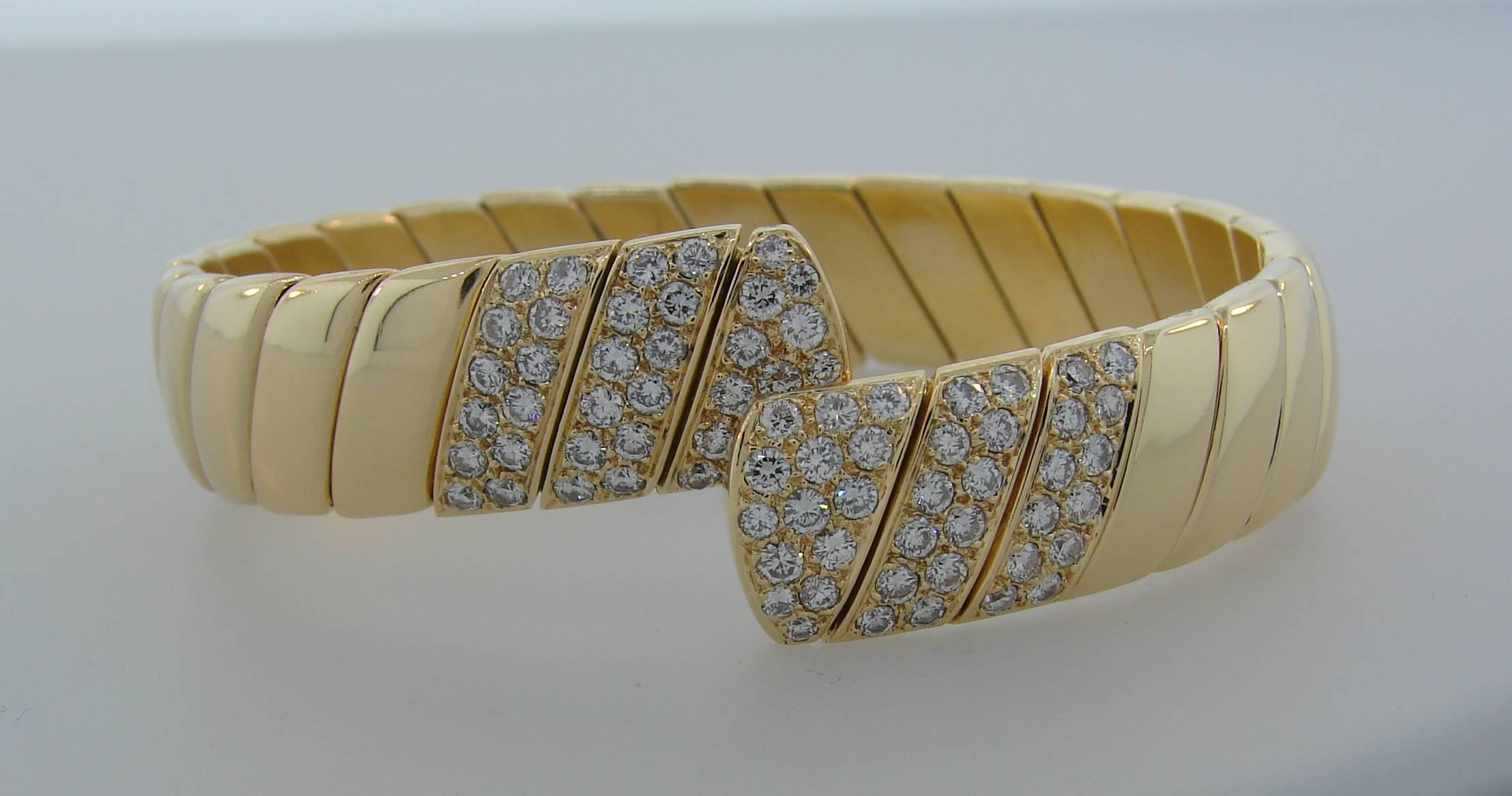 Classy and timeless bracelet created by Cartier in France in 1980s. Elegant and wearable, the bangle is a great addition to your jewelry collection. 
Made of 18 karat yellow gold and set with 1.85 carats of round brilliant cut diamonds (F-G color,