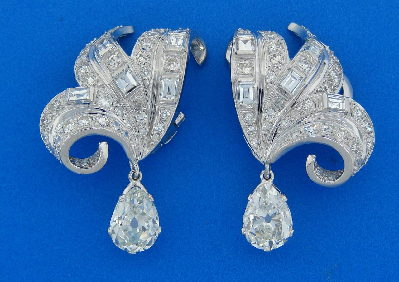 Stunning diamond & platinum earrings created by unknown jeweler during an Art Deco era in the 1930's. Feature two pear-shape diamonds - one is 2.25 carat (K color, SI2 clarity), the other one is 2.29 carat (M color, VS2 clarity) and additional round