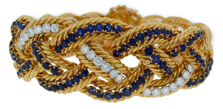 Elegant feminine bracelet created by Boucheron, Paris in 1960's. Rich and classy braided design, perfect proportions, tasteful color combination - are the highlights of this prominent piece of jewelry.
It is made of yellow gold and encrusted with